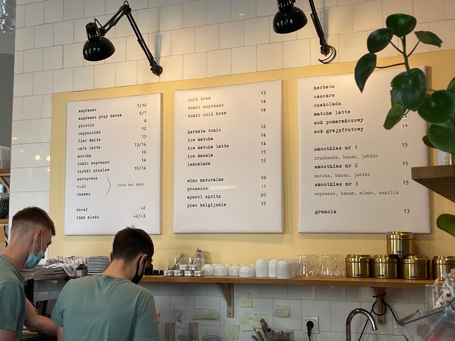 a man standing at a counter in a cafe