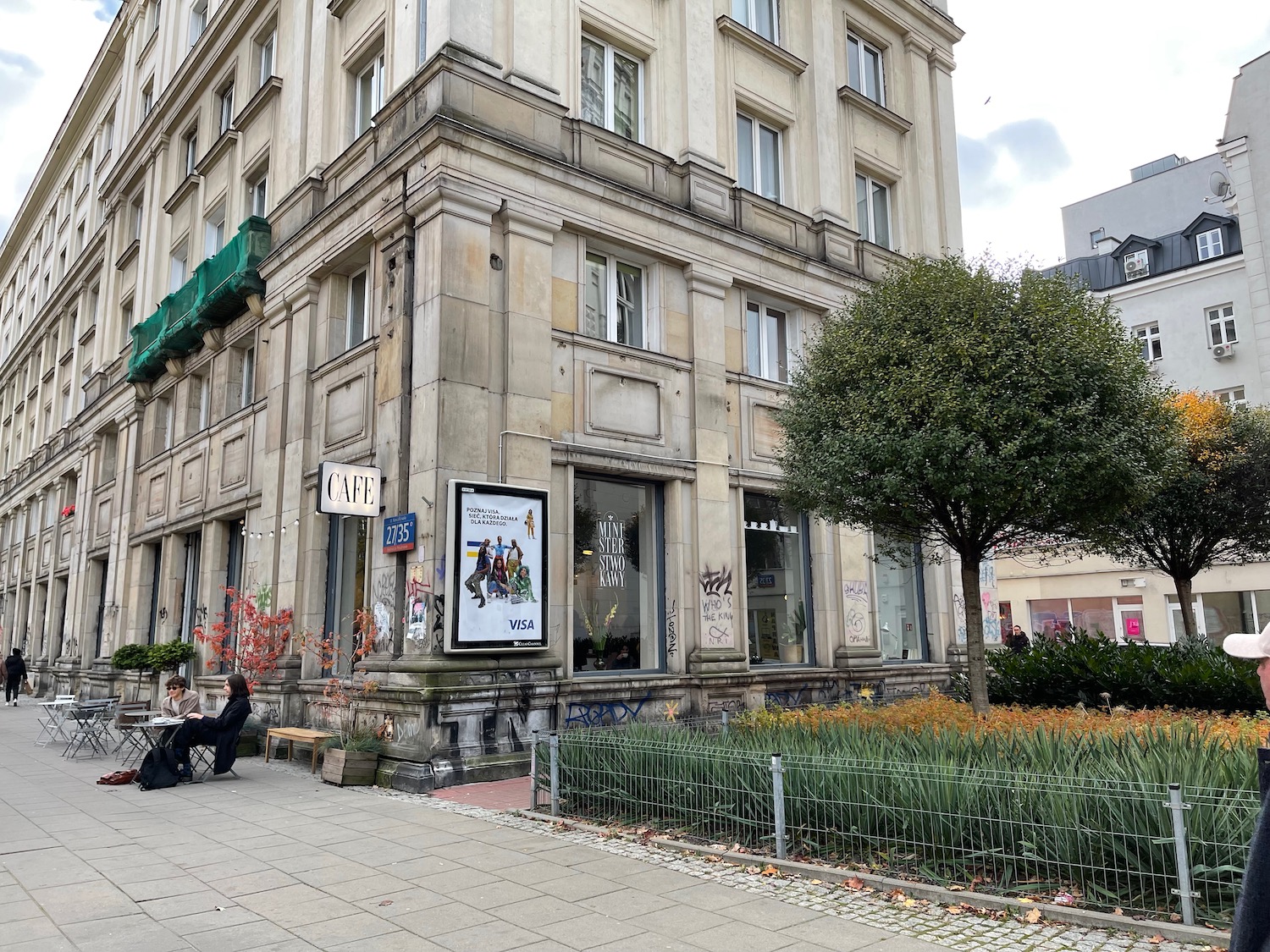 a building with a tree and a bench