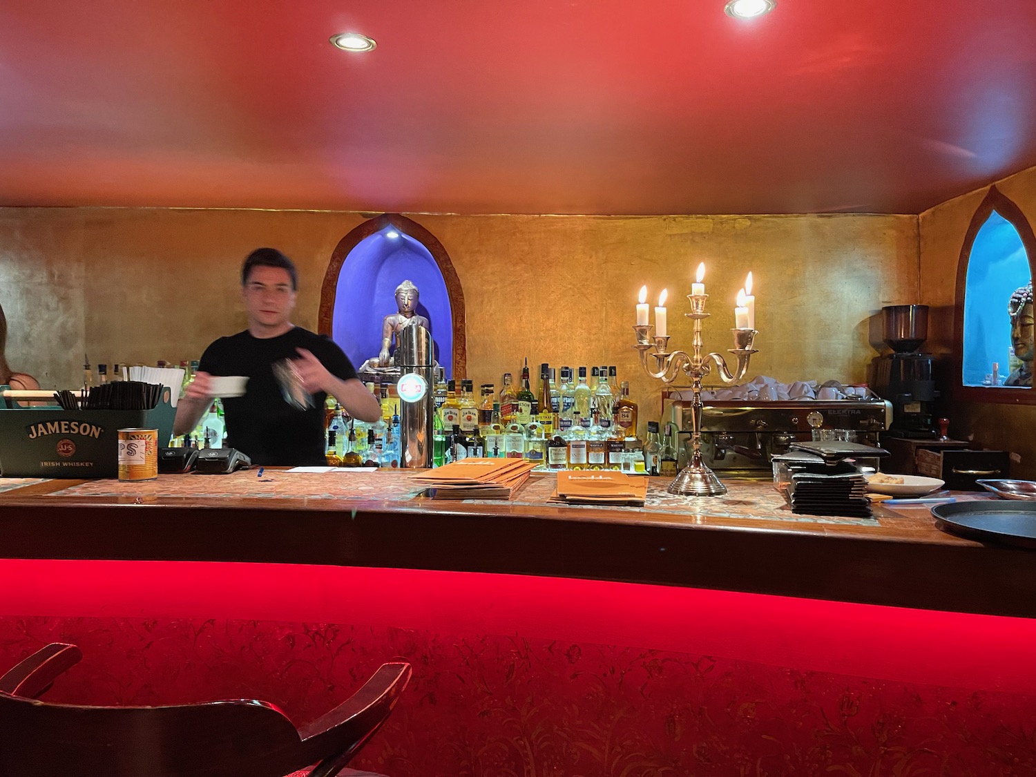 a man standing behind a bar