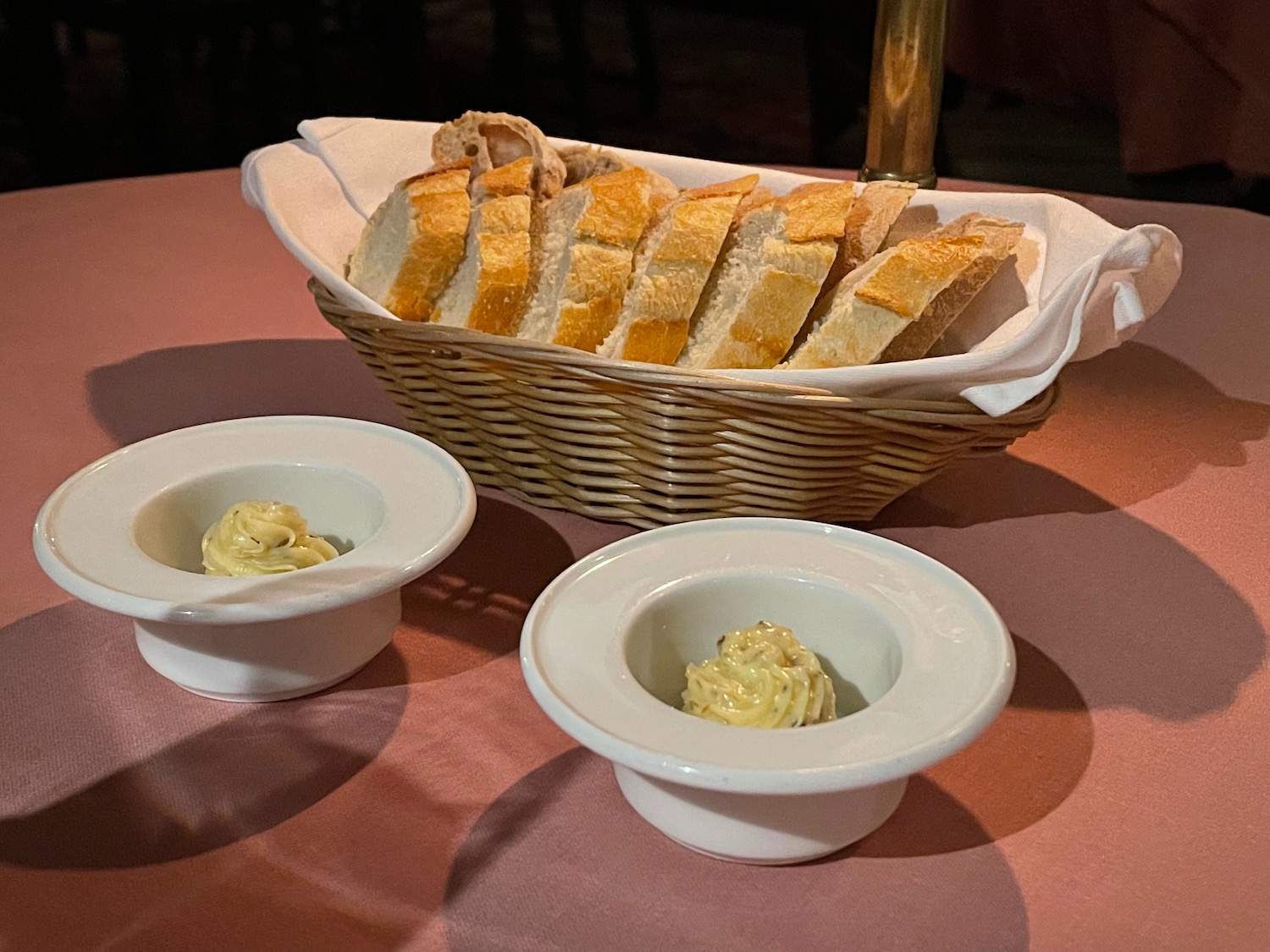 a basket of bread and dips on a table