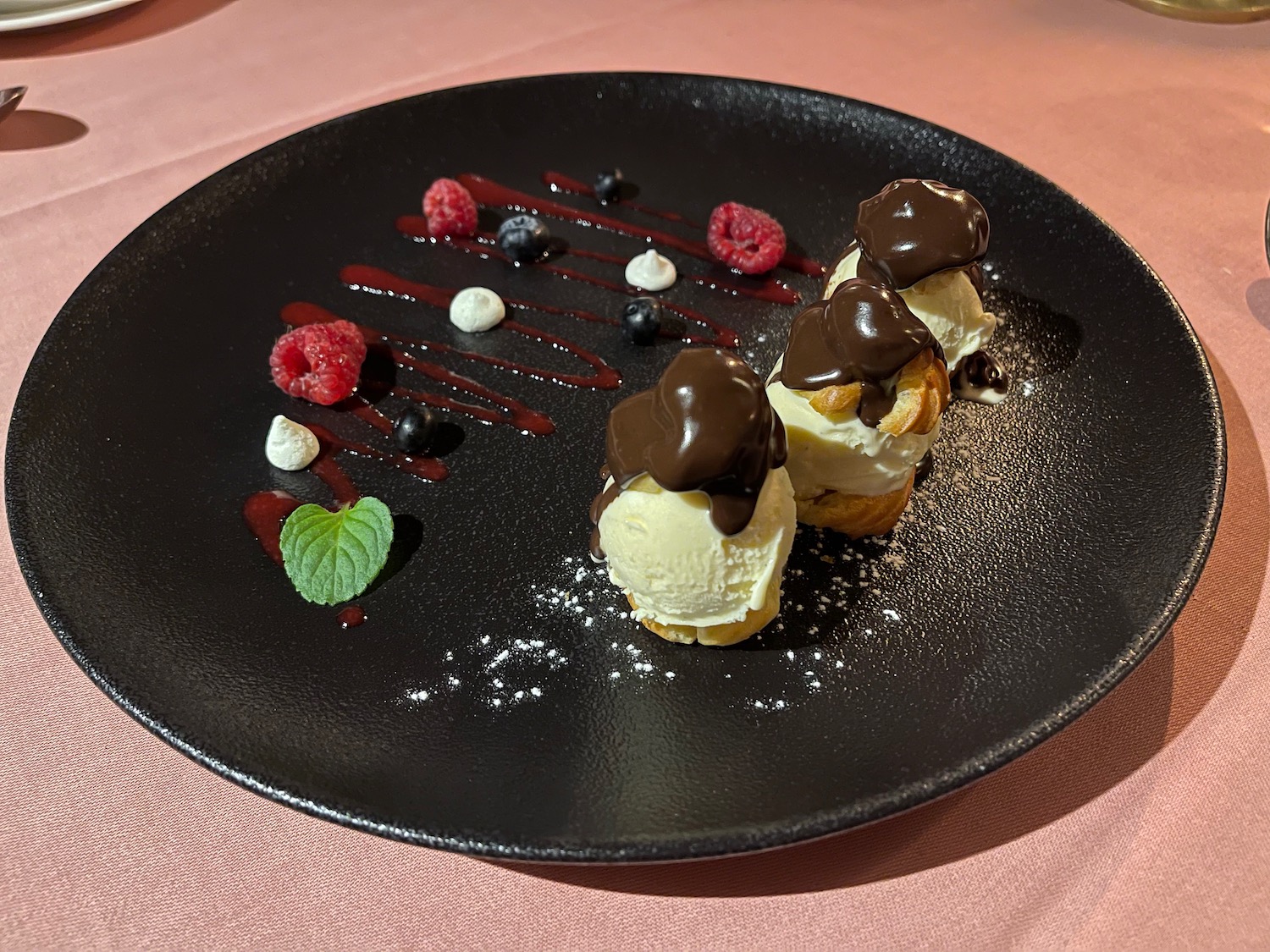 a plate of desserts with berries and chocolate on it