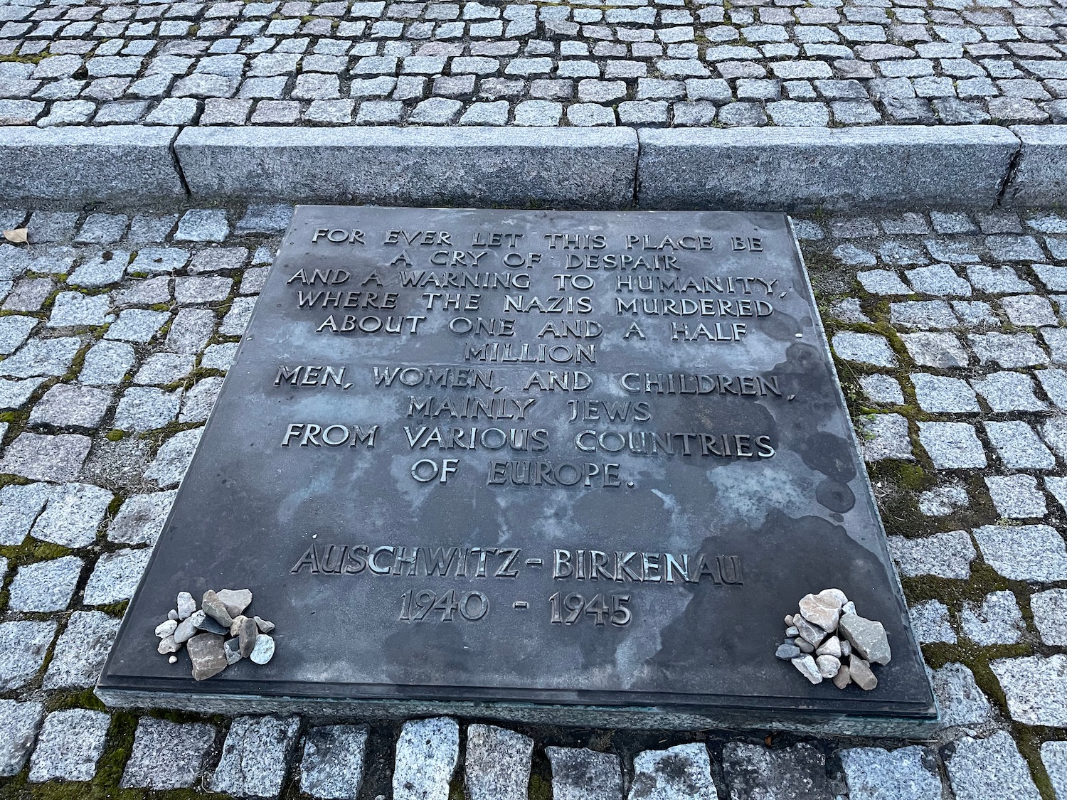 a stone plaque on a cobblestone