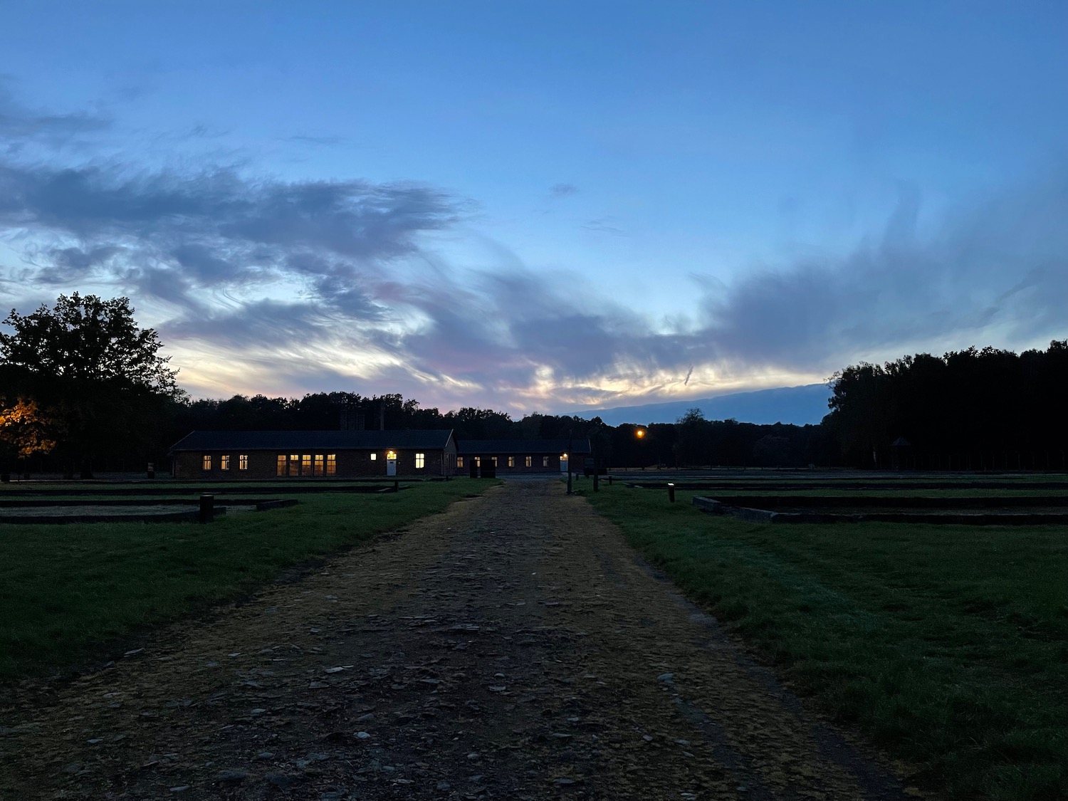 a dirt road leading to a building