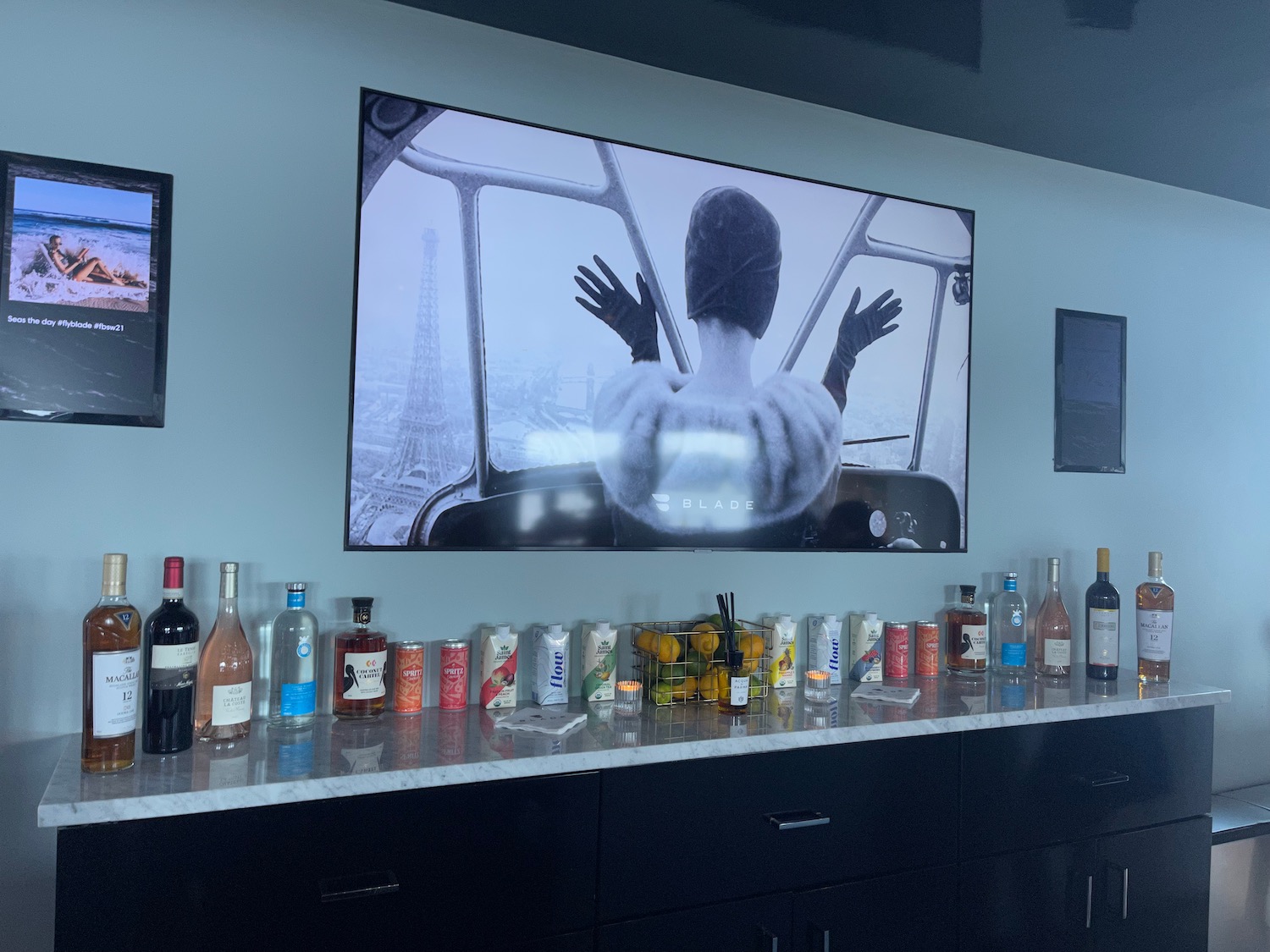 a bar with a television and bottles of alcohol