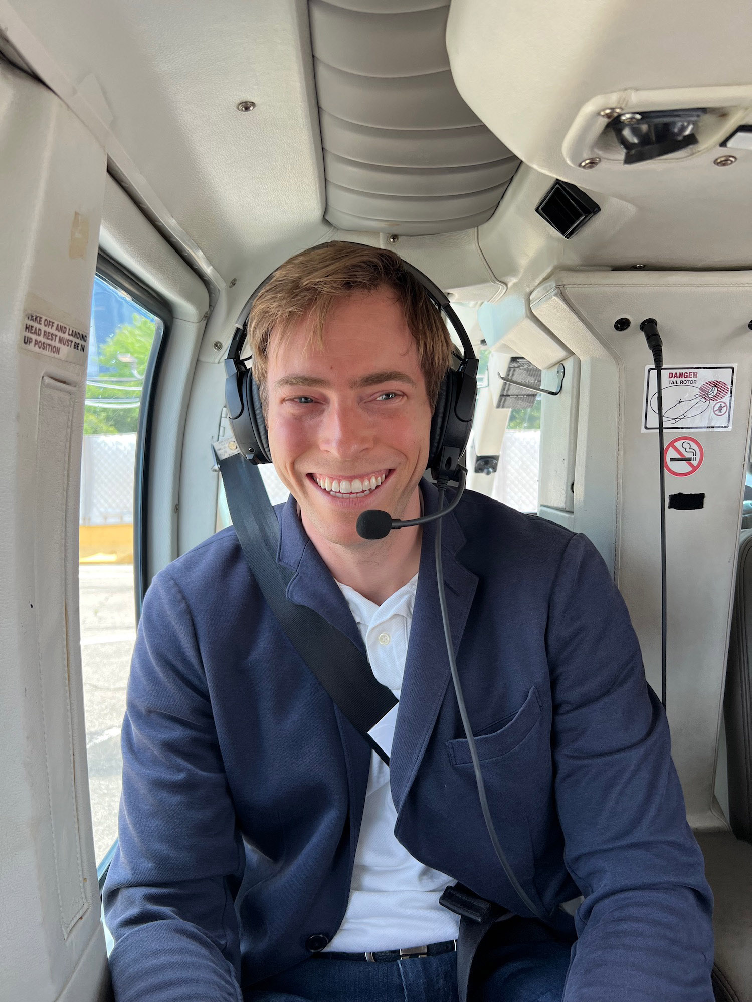 a man wearing a headset and sitting in a helicopter