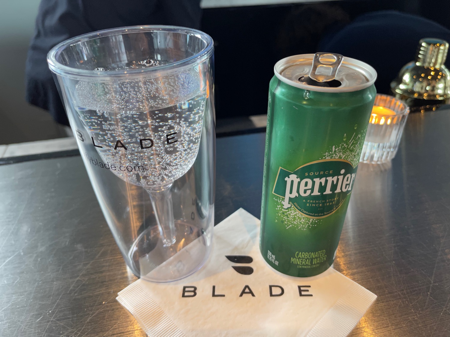 a can and glass of water on a table