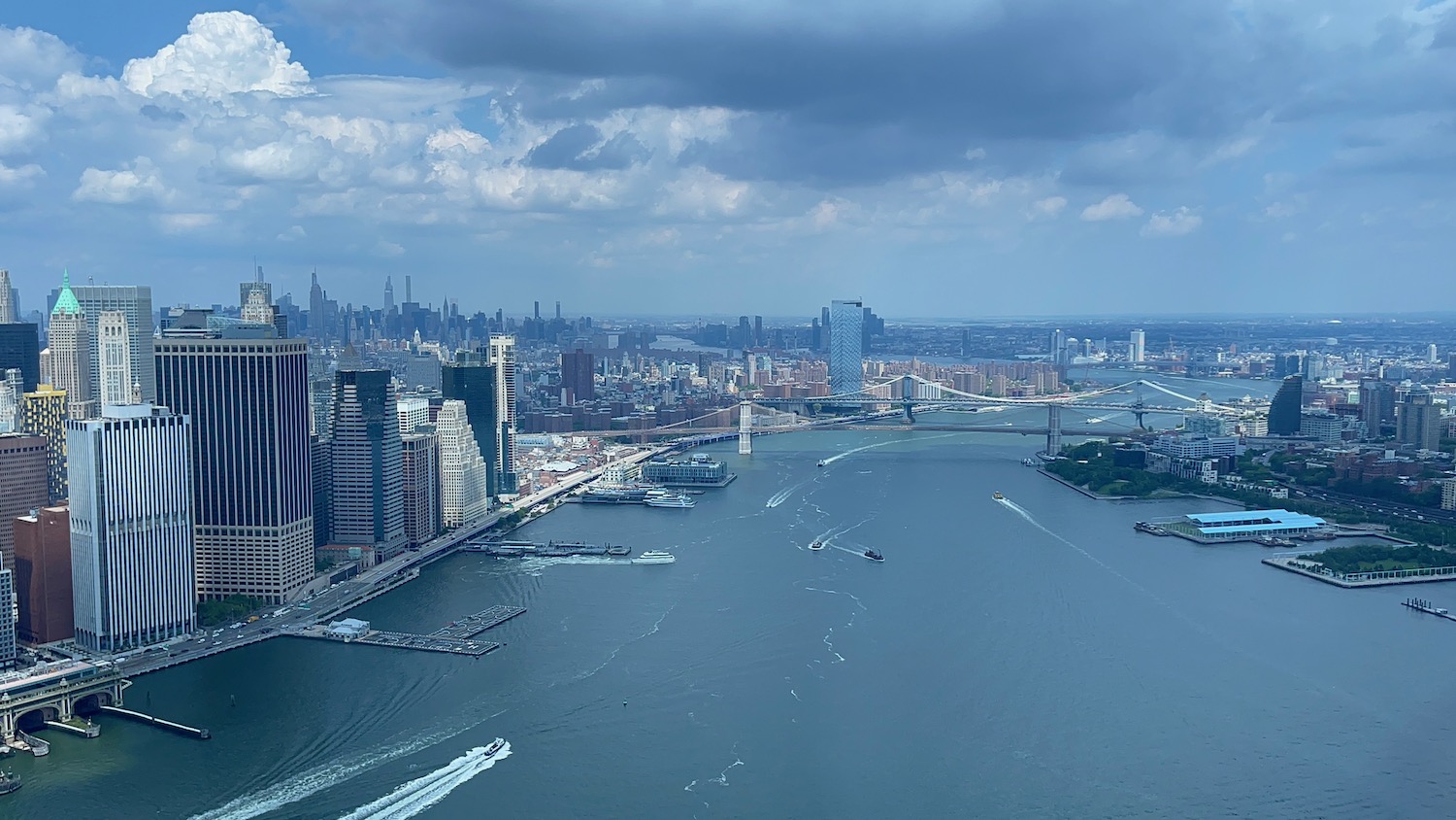 a city with a bridge and boats