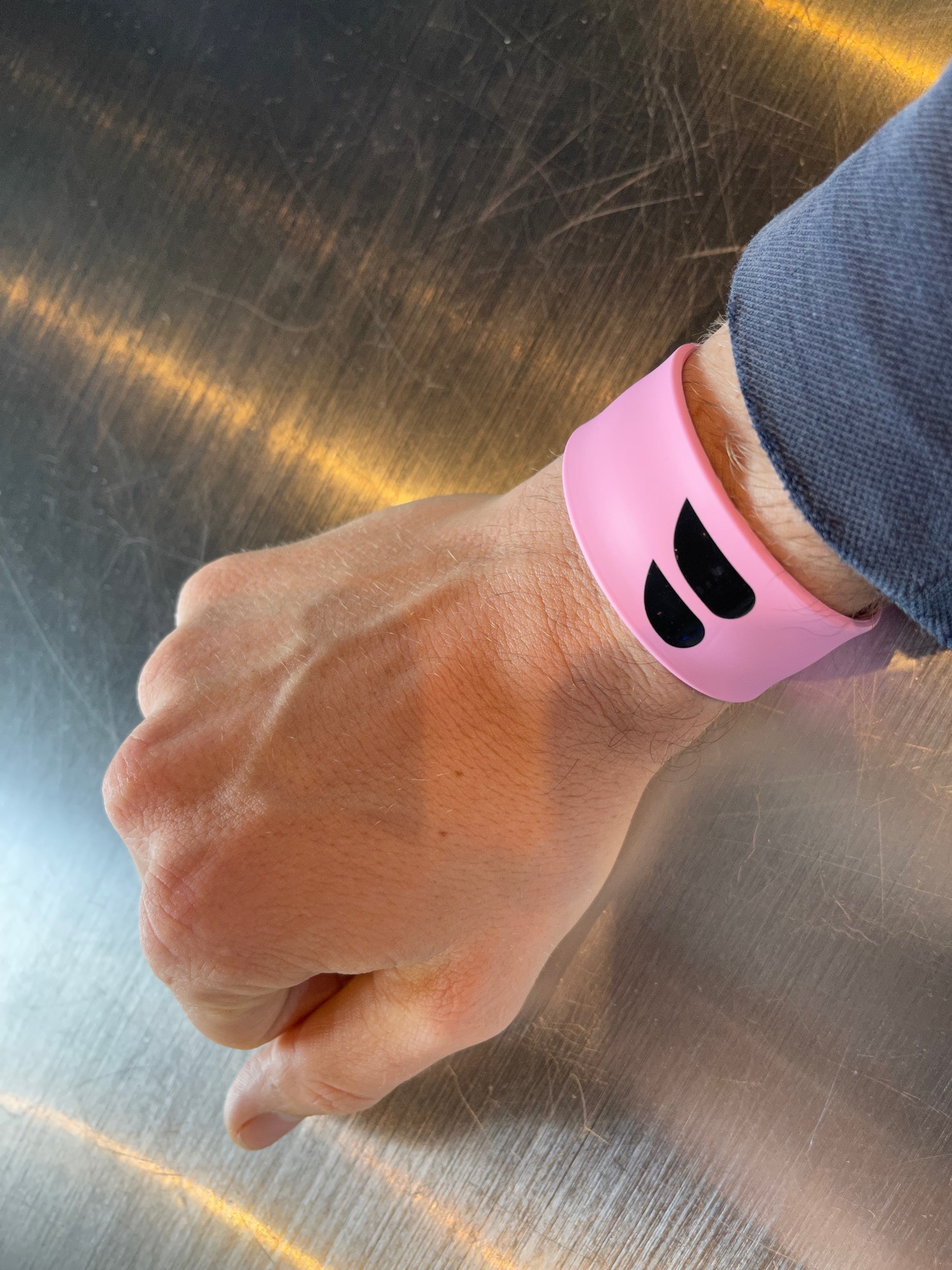a person wearing a pink wristband