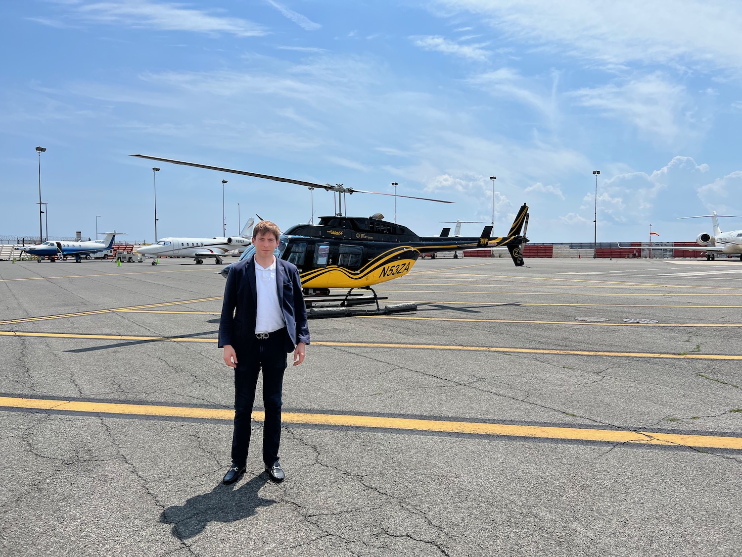 a man standing in front of a helicopter