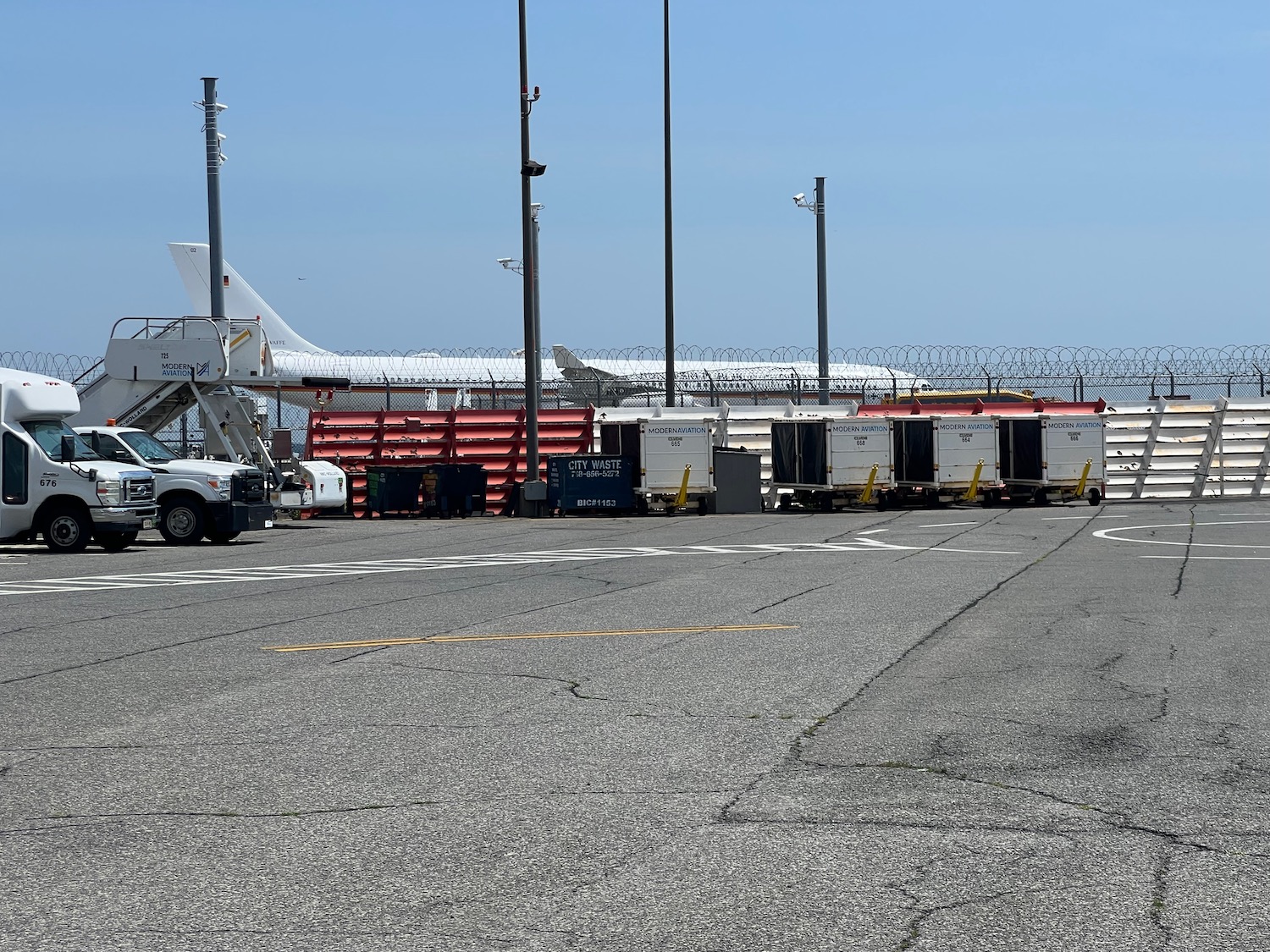 a white truck parked next to a white airplane