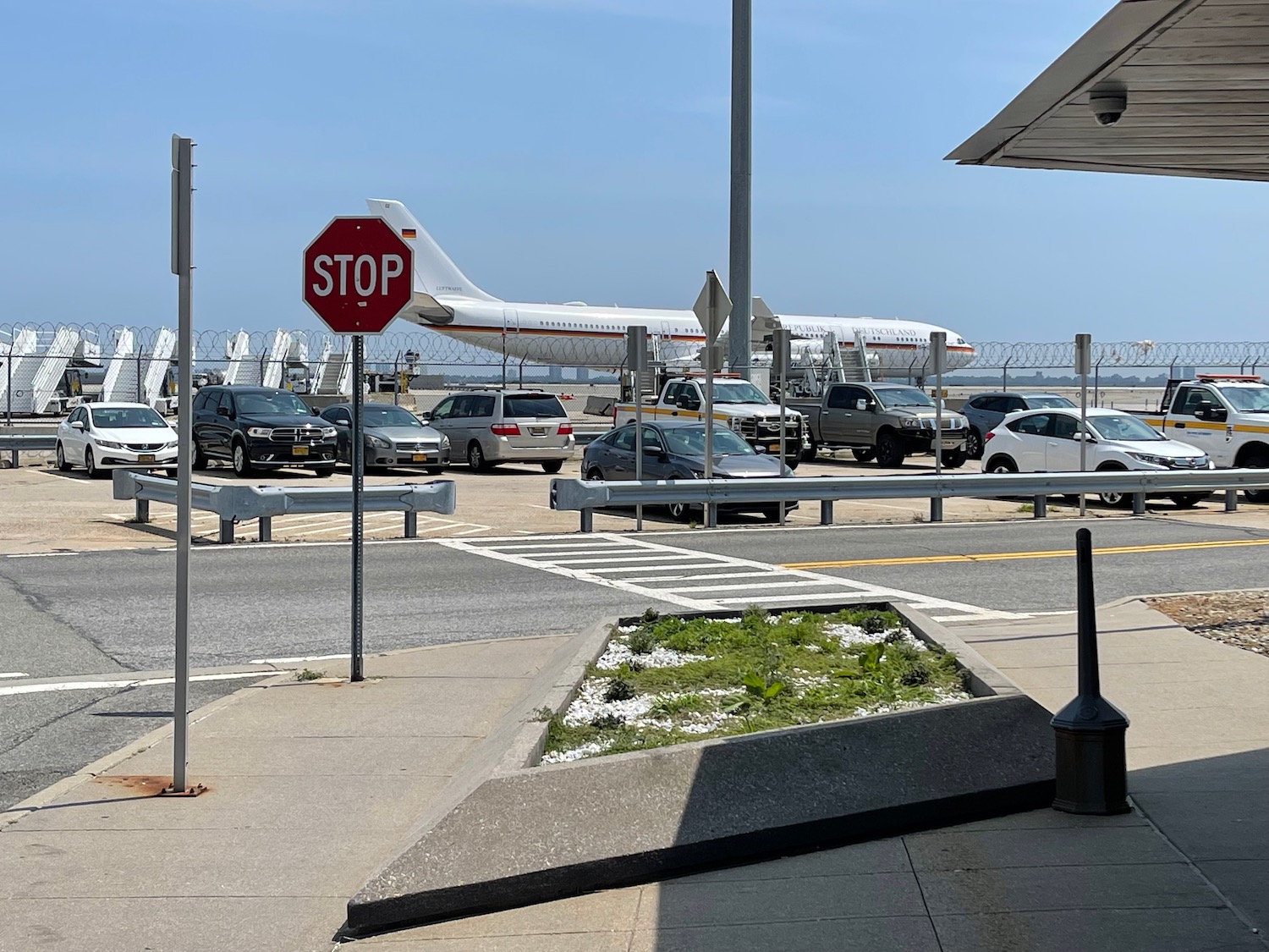 a stop sign and cars in a parking lot