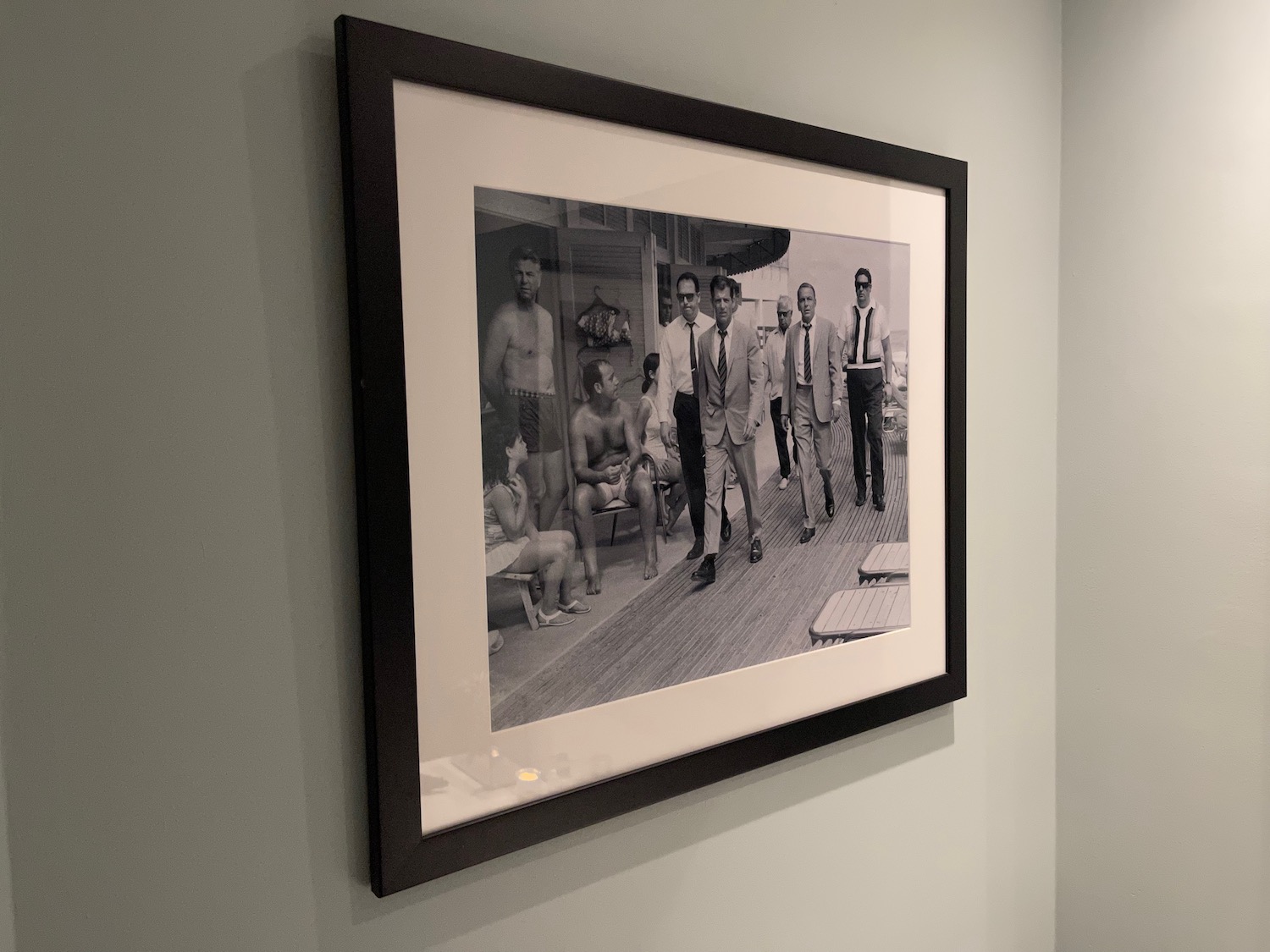 a black and white picture of a group of men in a black frame on a wall