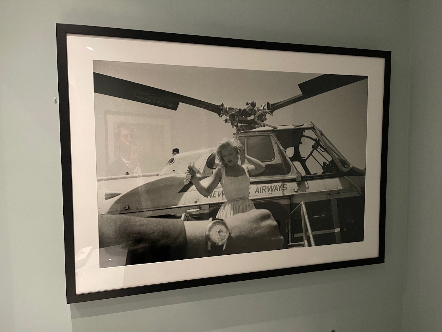 a black and white photo of a woman in a white dress and a helicopter