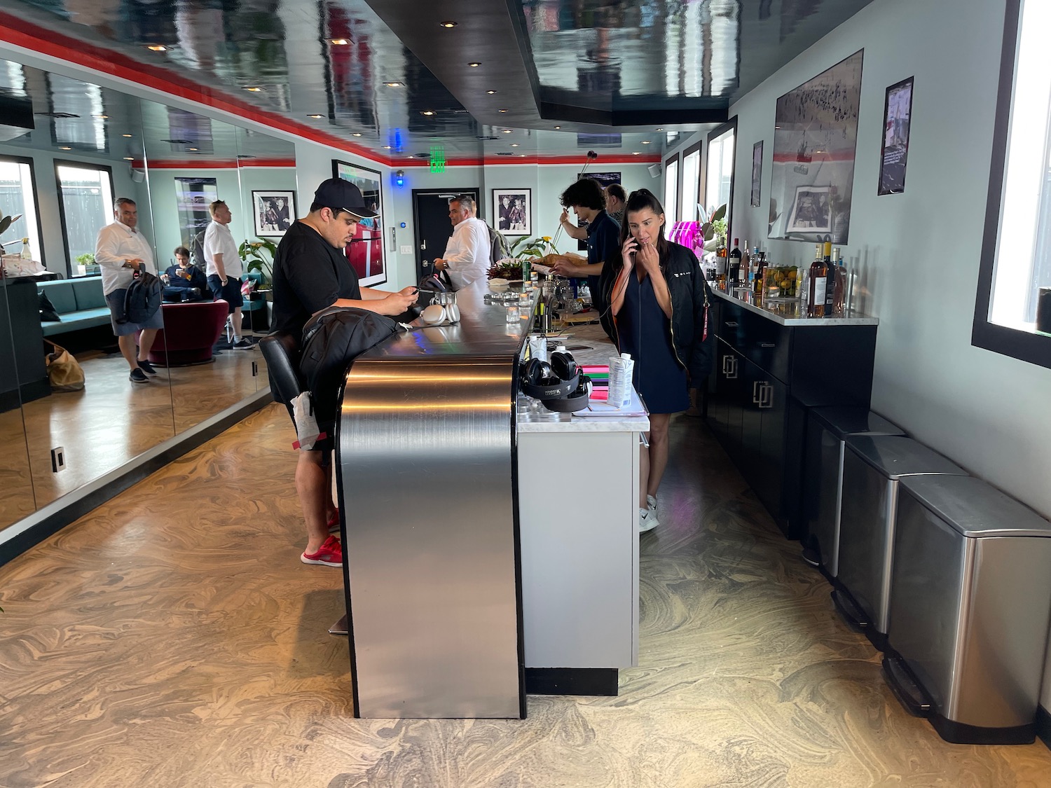 people standing at a counter in a bar