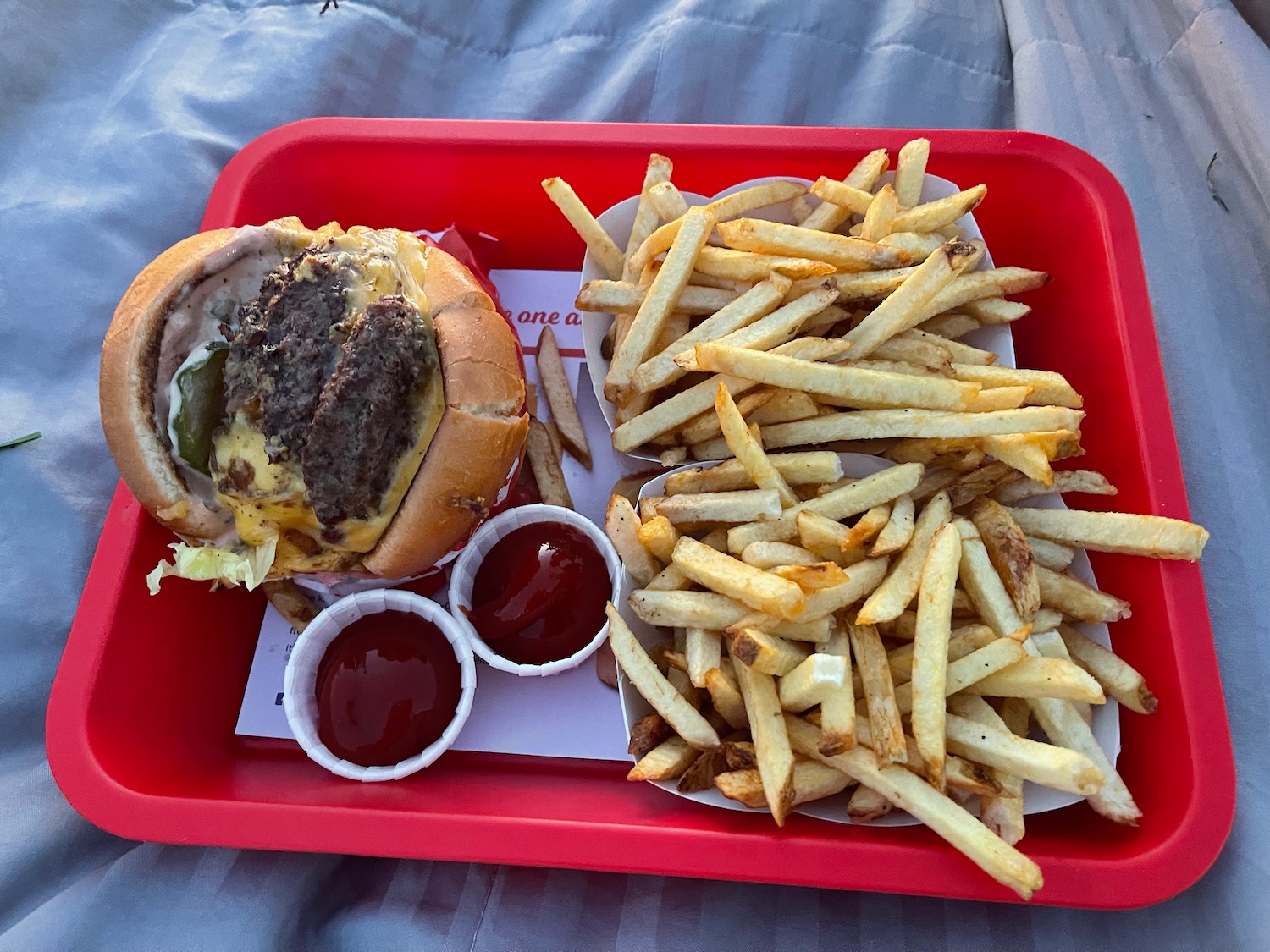 a tray of french fries and burger