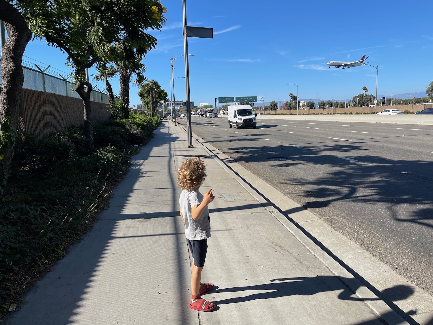 a child standing on a sidewalk