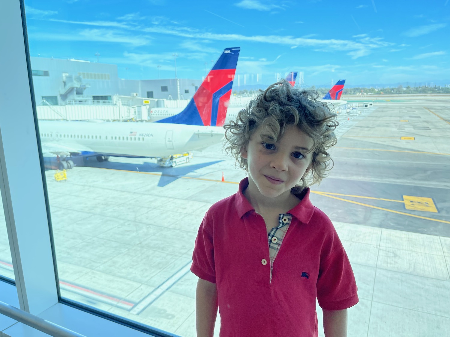 a boy standing in front of a window