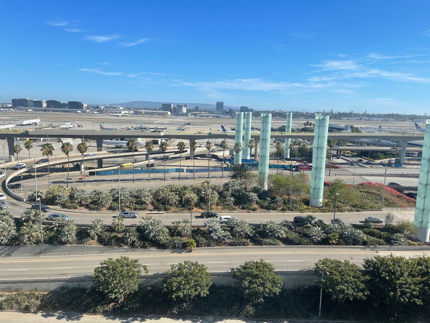 a highway with many cars and a bridge