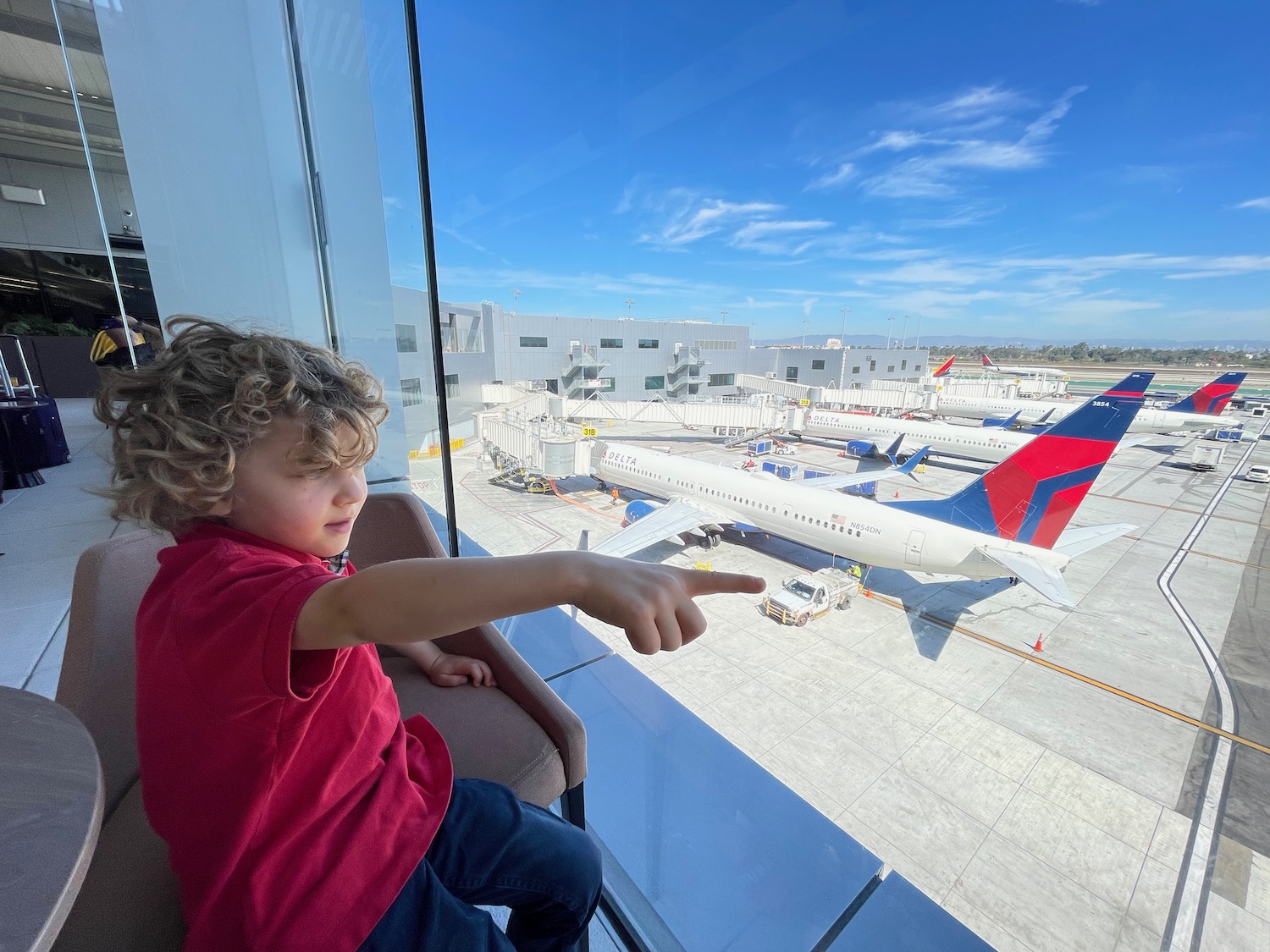a child pointing at an airplane