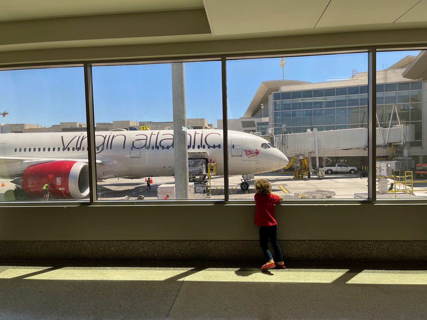 a child looking at an airplane