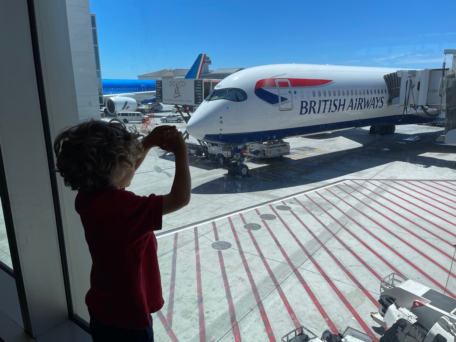 a child looking out a window at an airplane