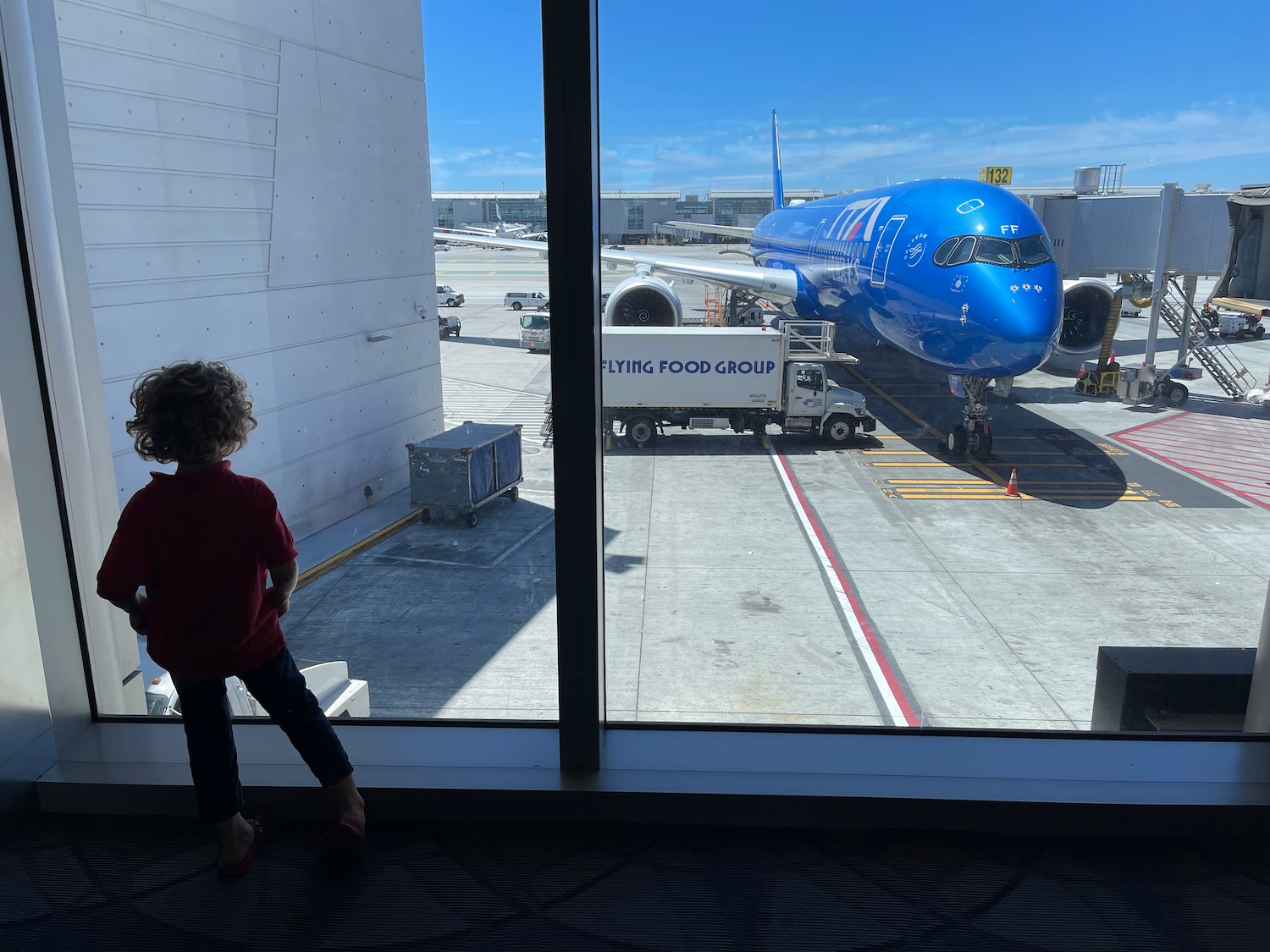 a child looking at an airplane