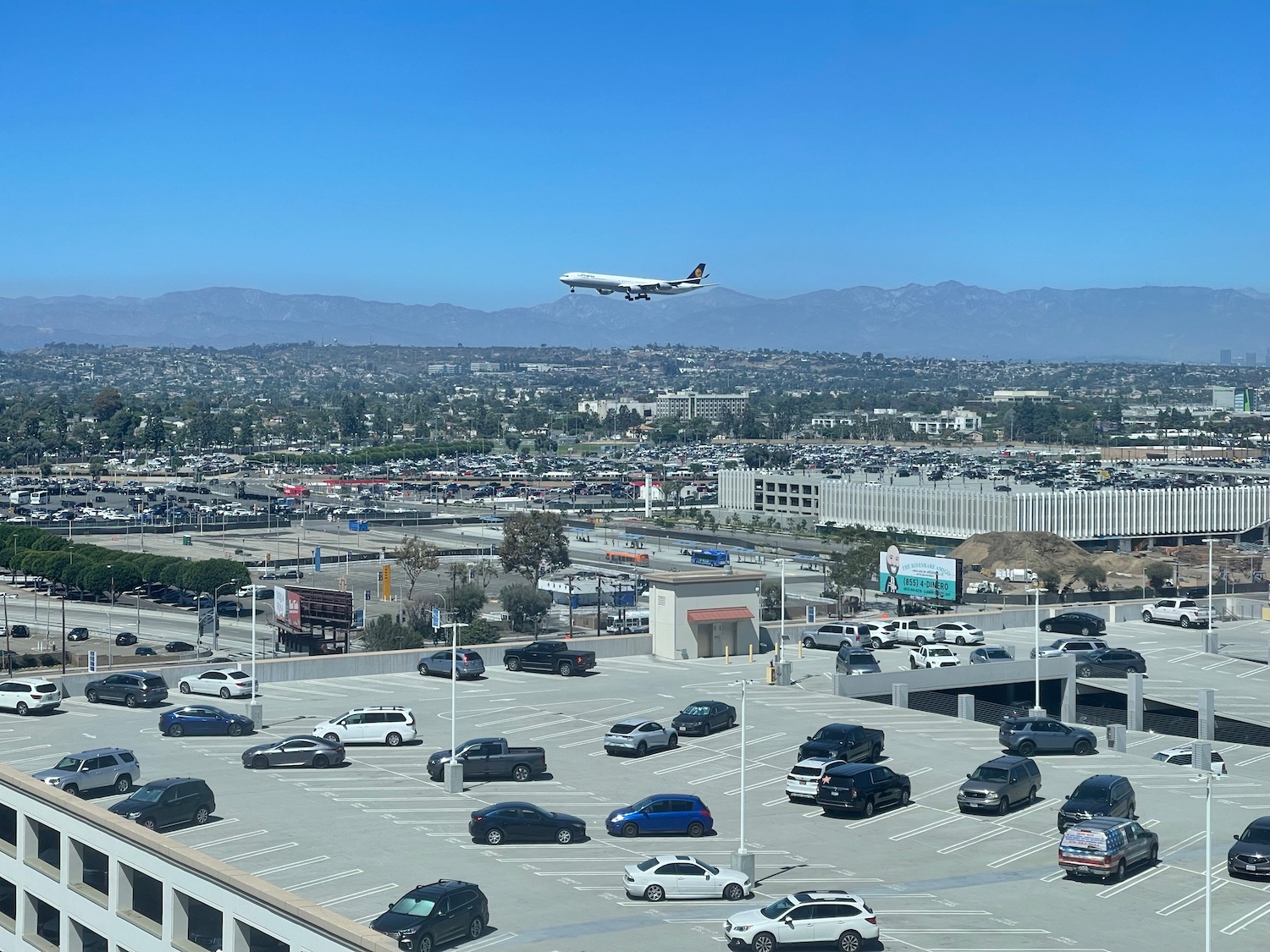 a plane flying over a parking lot