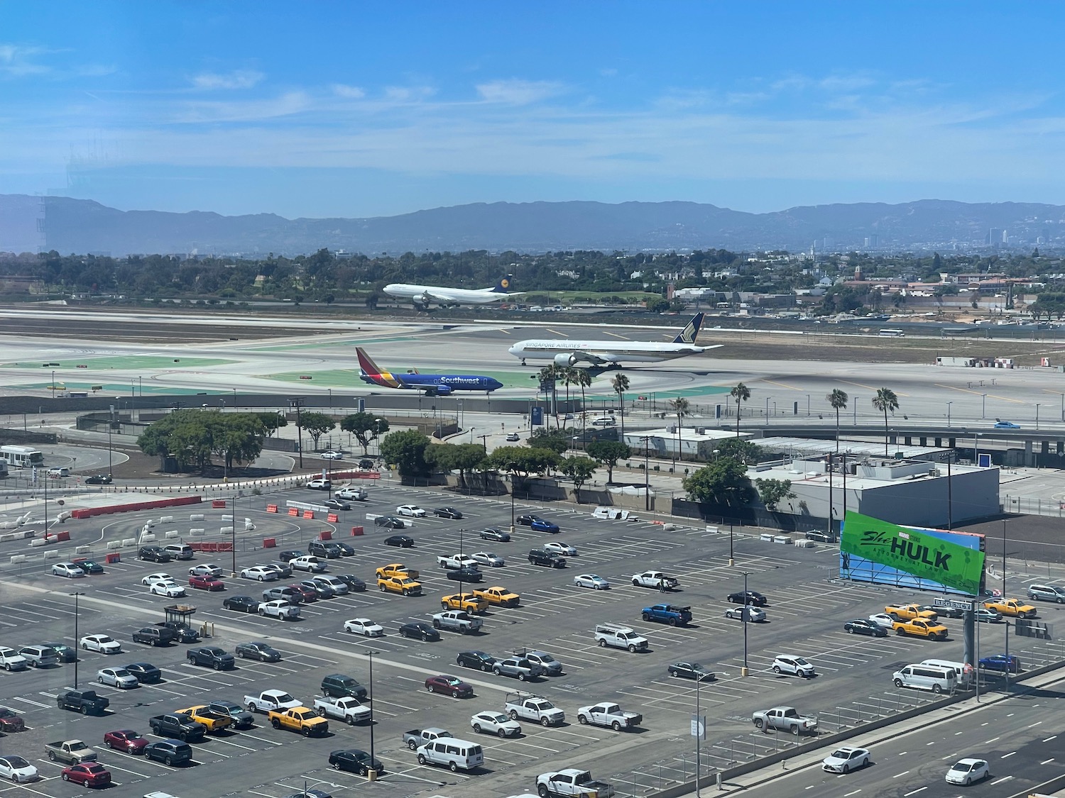 an airport with many cars and airplanes