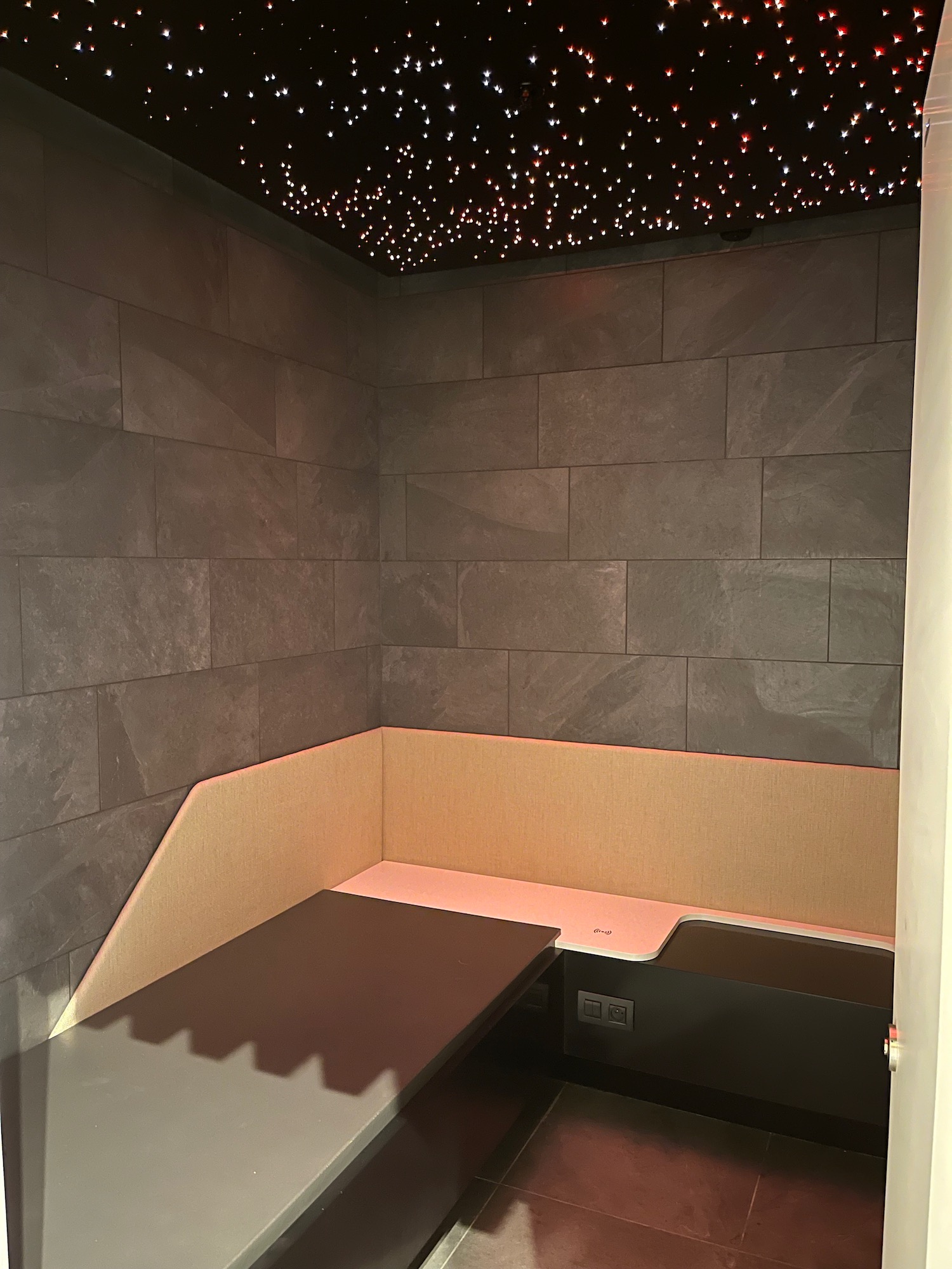 a corner booth with a table and a wall