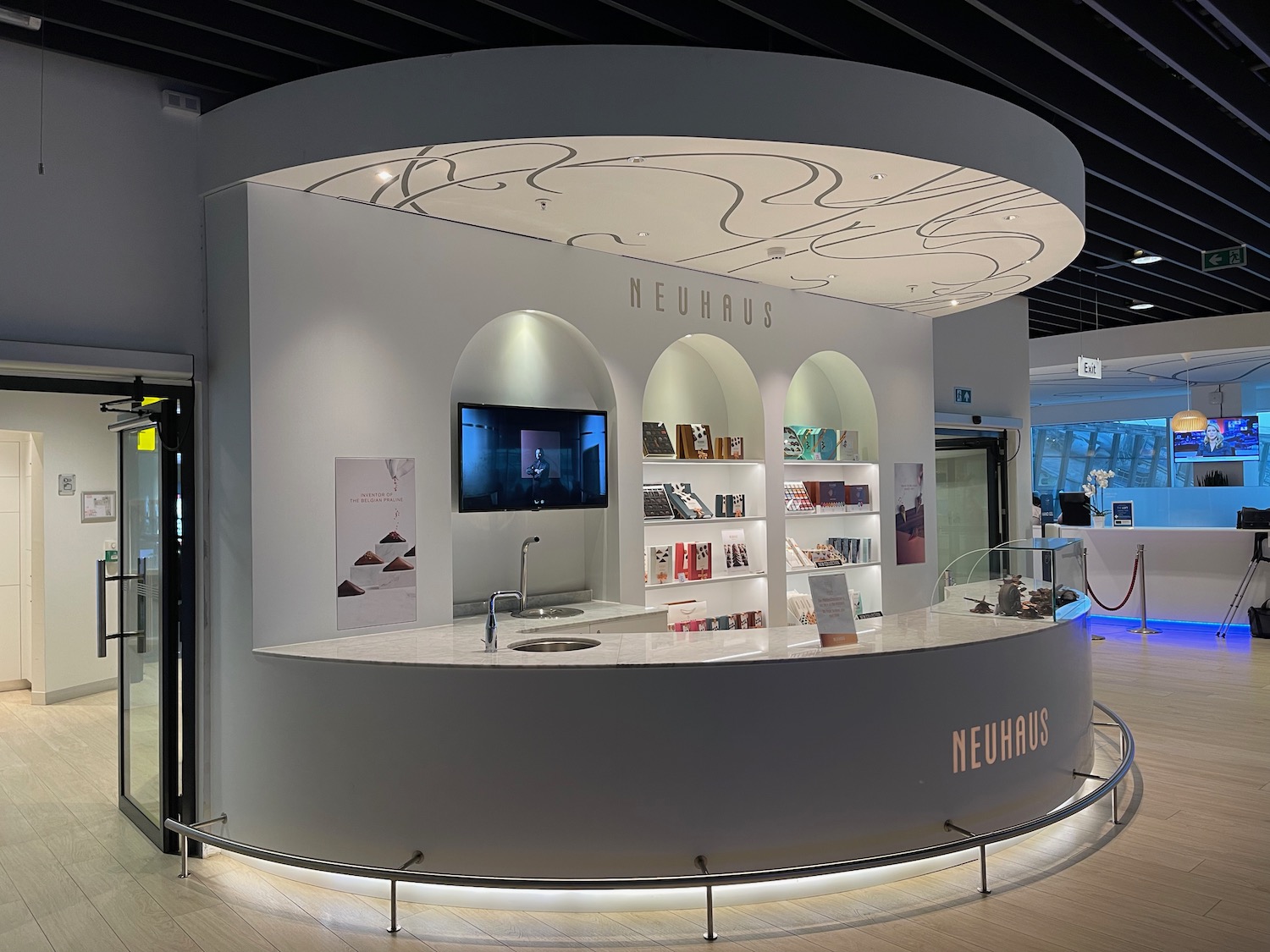 a white counter with a tv and shelves