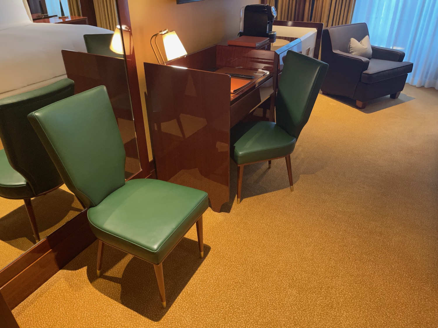 a room with green chairs and a desk