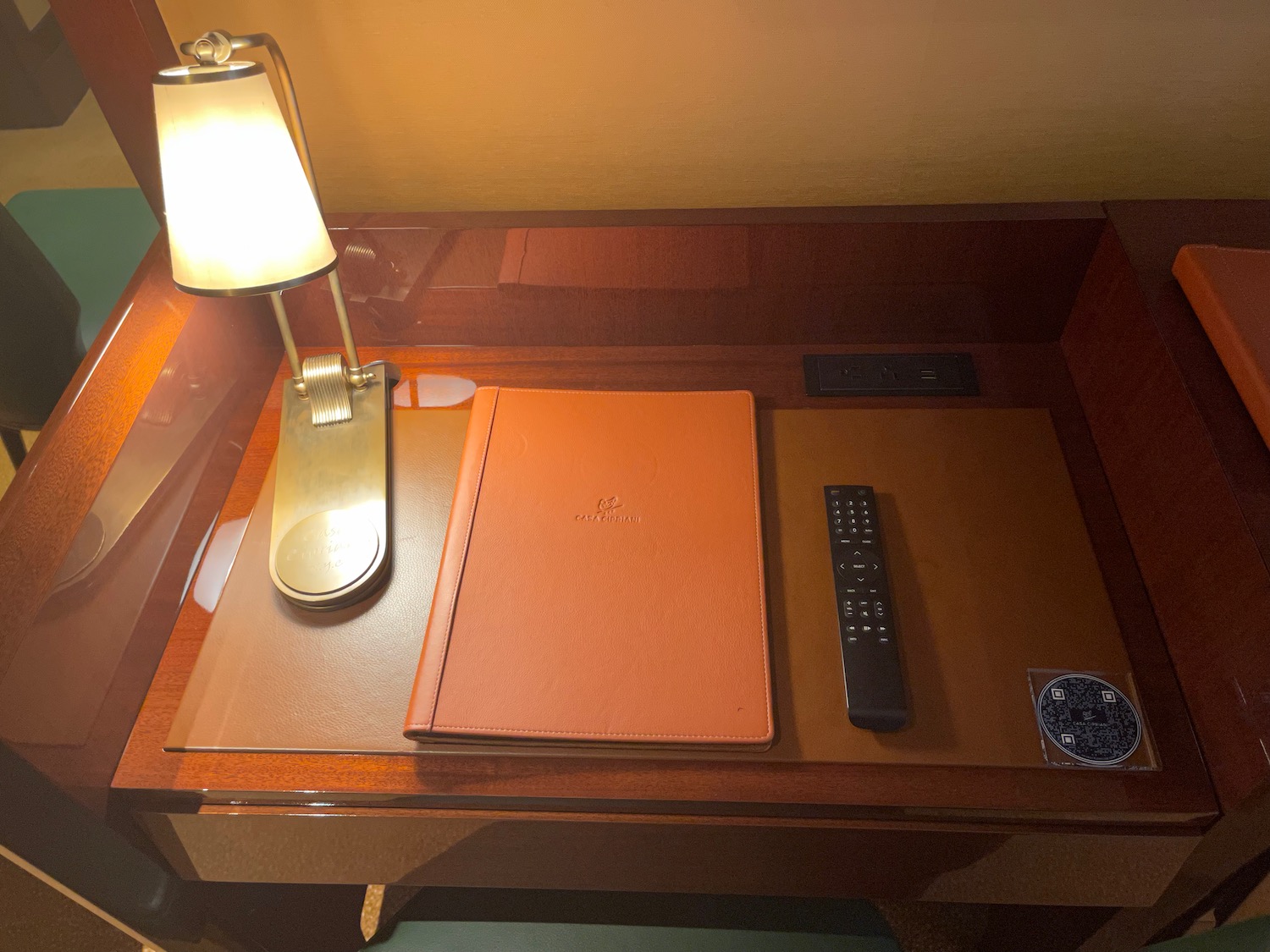 a desk with a remote control and a book