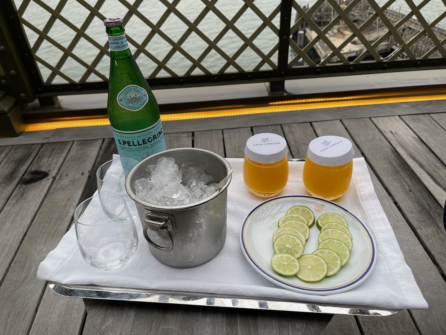 a plate of limes and a bottle of wine on a table