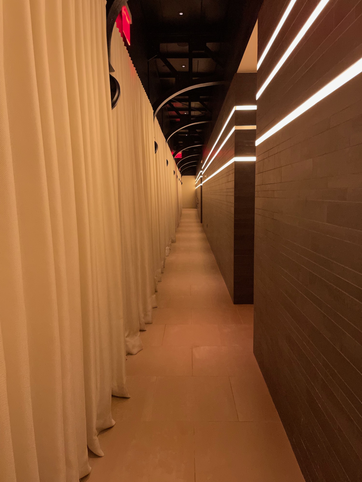 a long hallway with white curtains