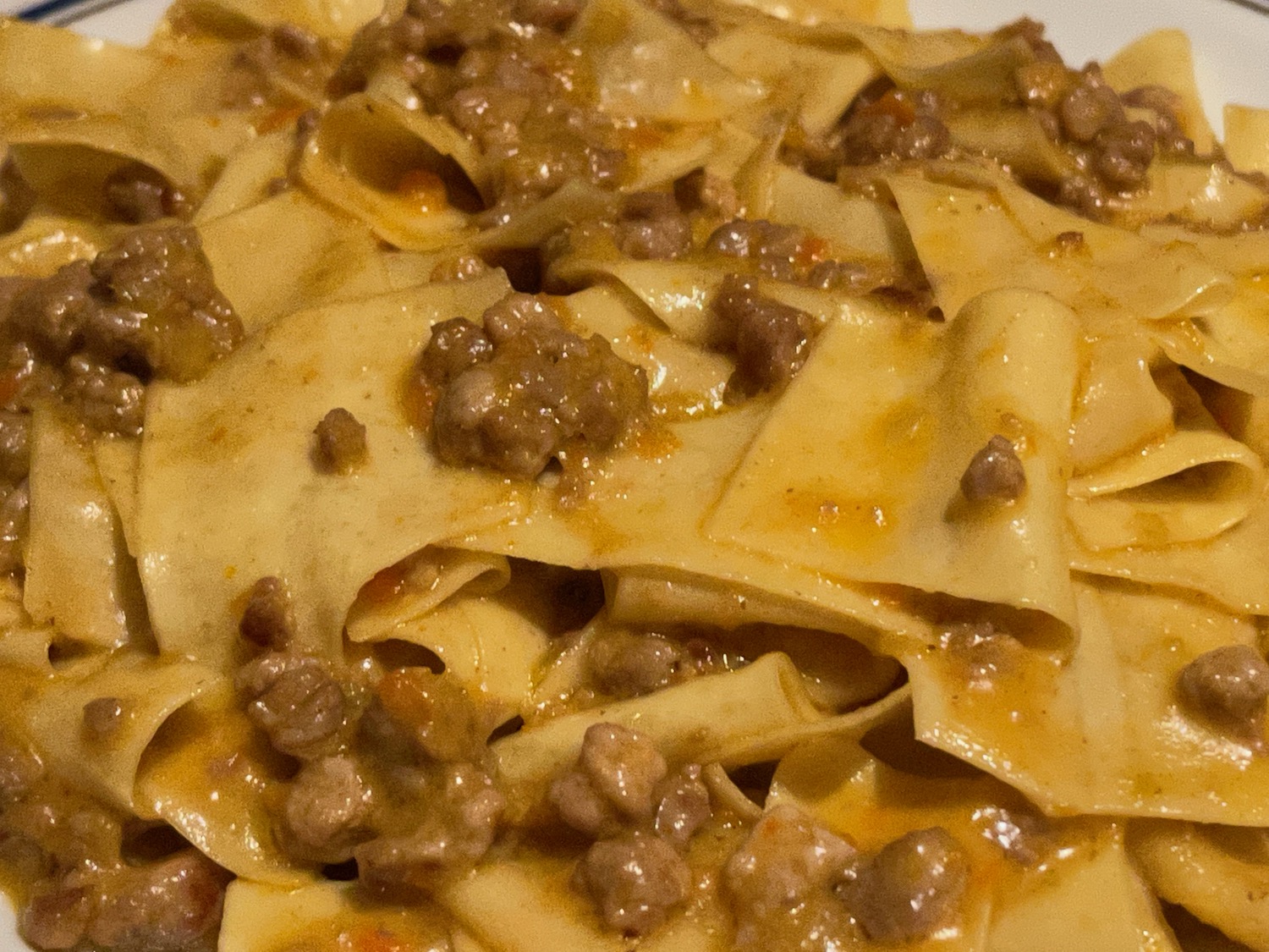 a plate of pasta with meat and sauce