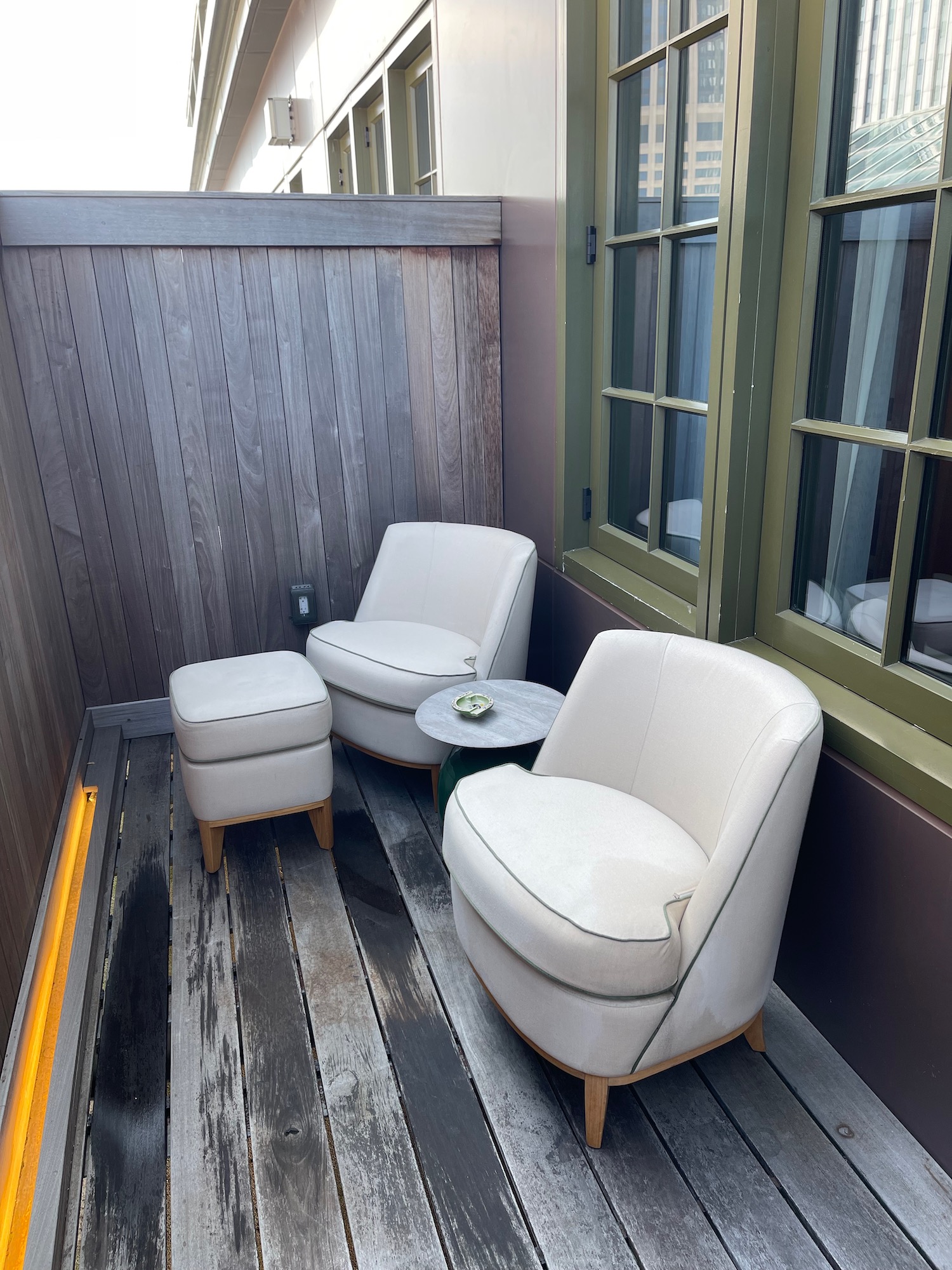 a white chairs and a table on a wooden deck