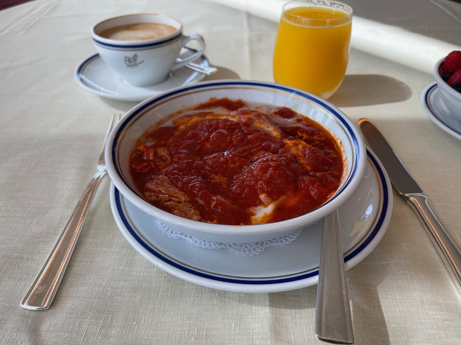 a bowl of red sauce and a cup of coffee