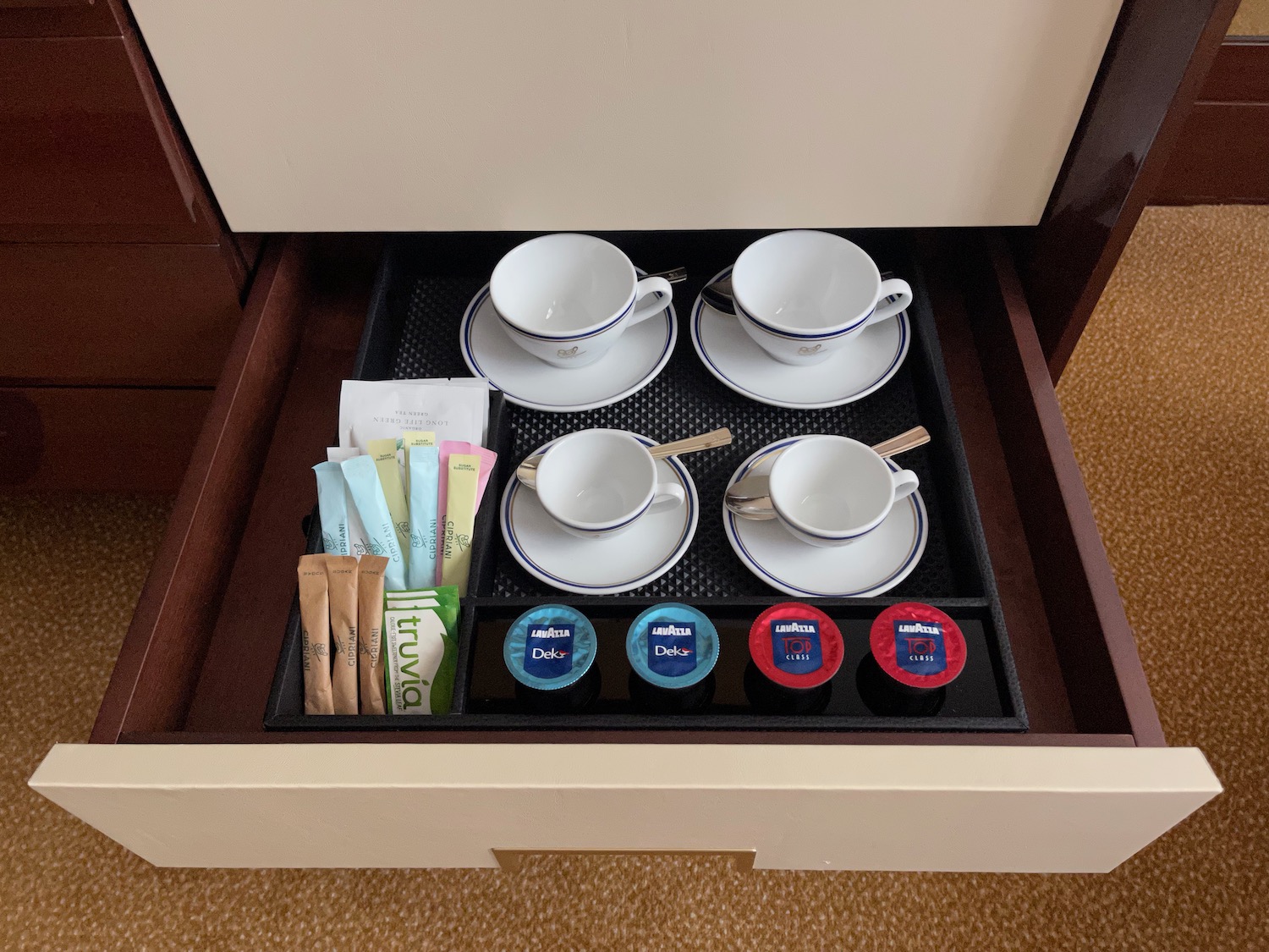 a drawer with tea cups and saucers