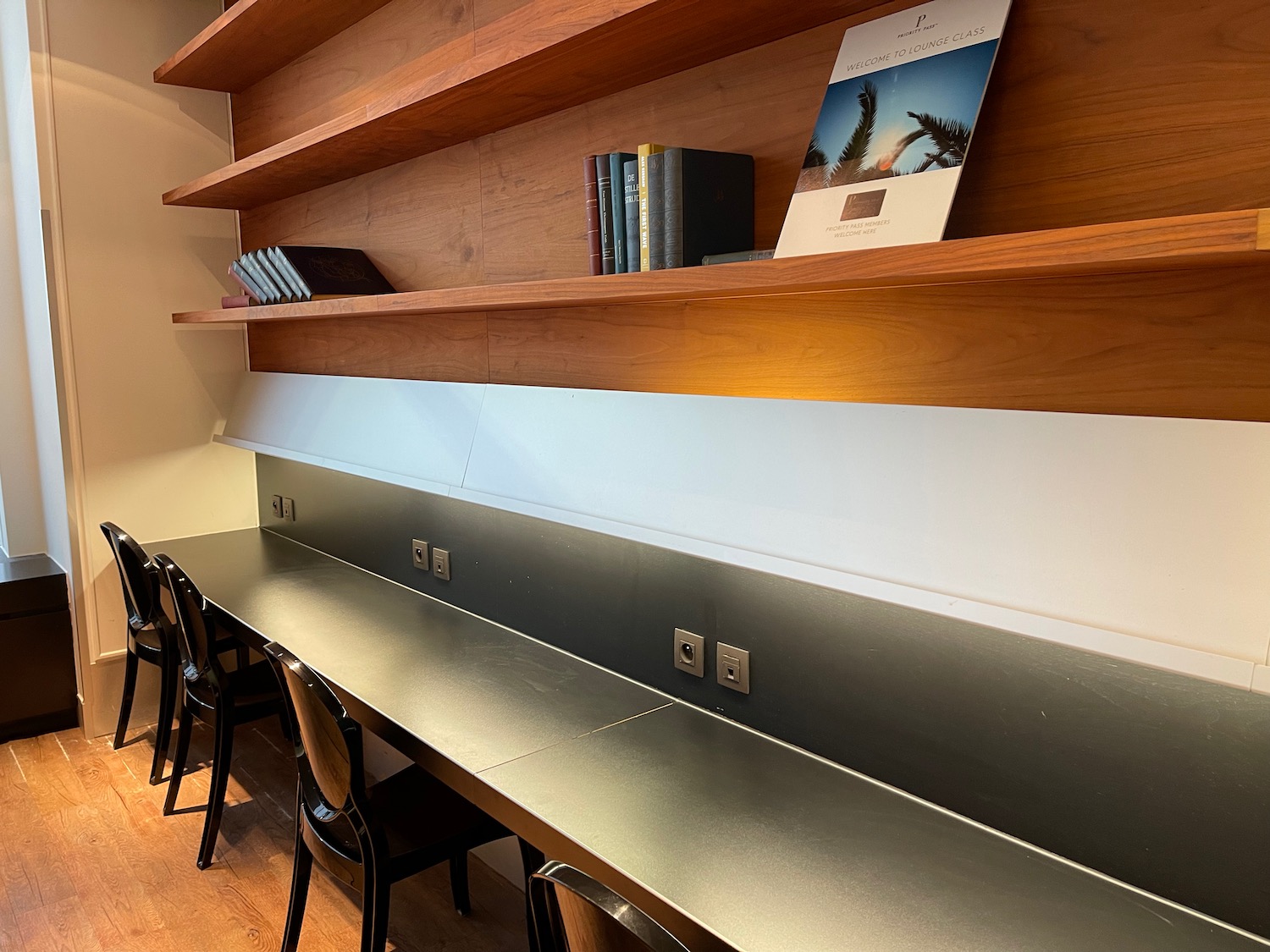 a desk with chairs and books on it