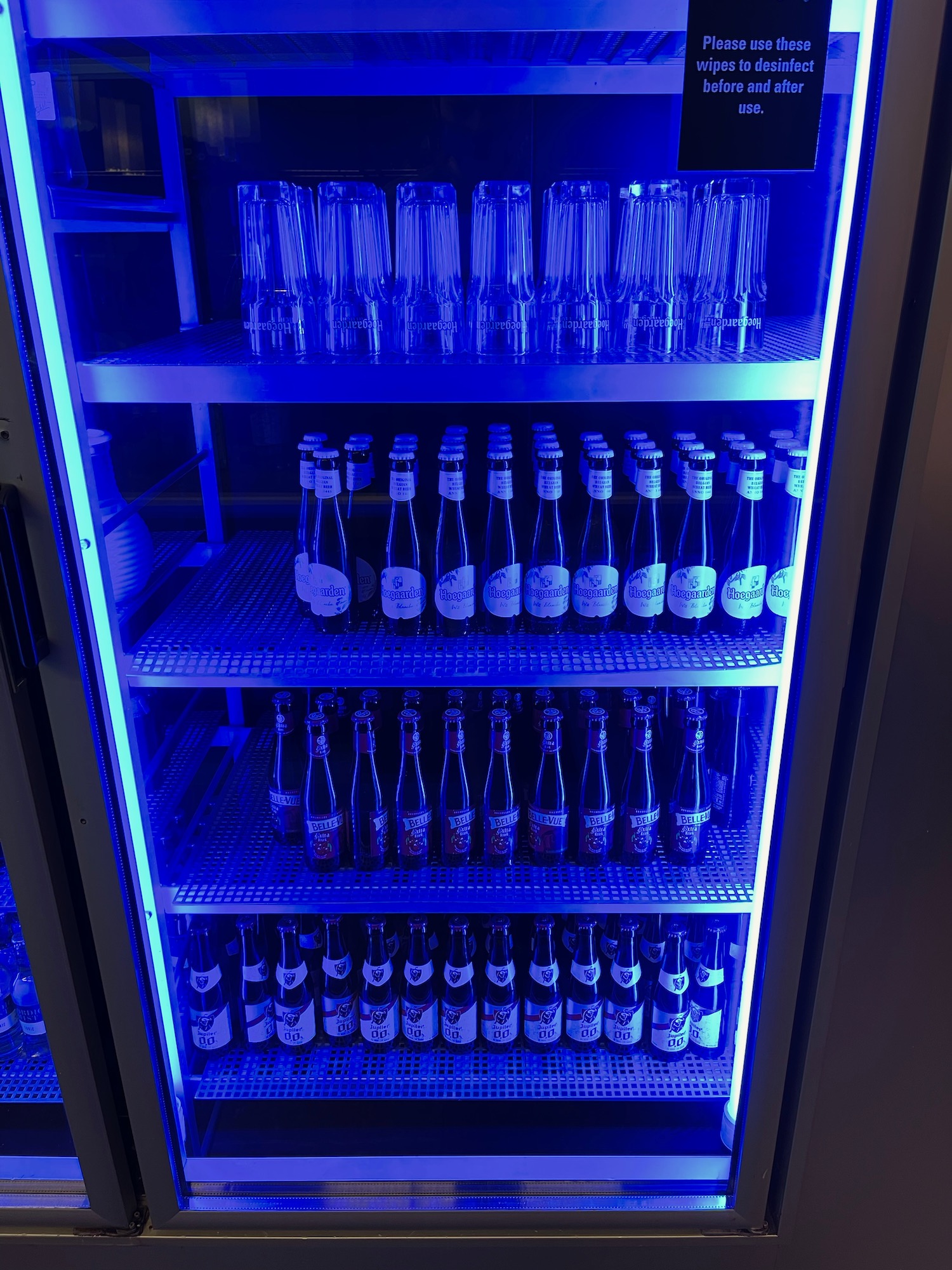 a shelf with bottles and glasses