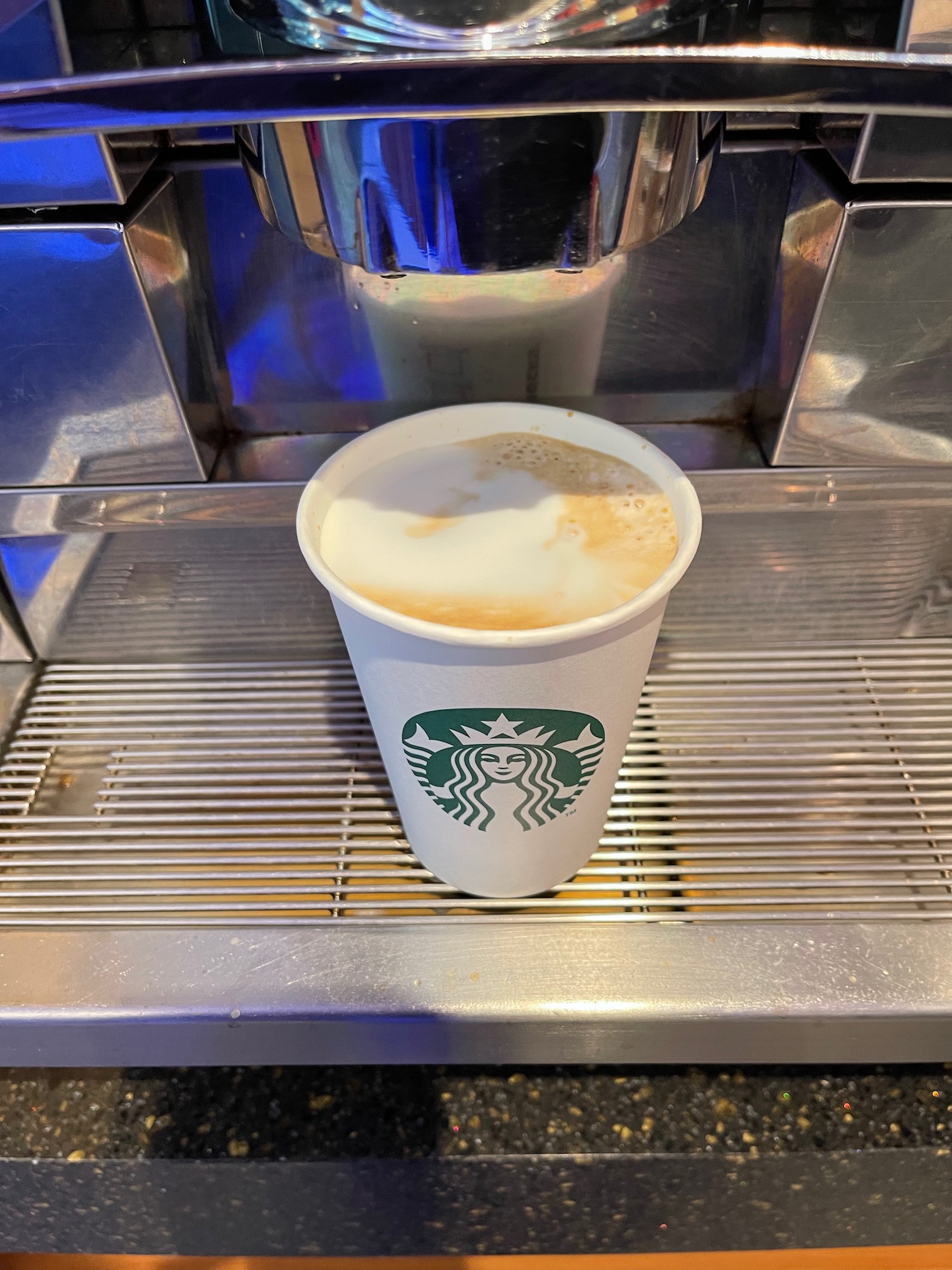 a coffee machine with a cup of coffee