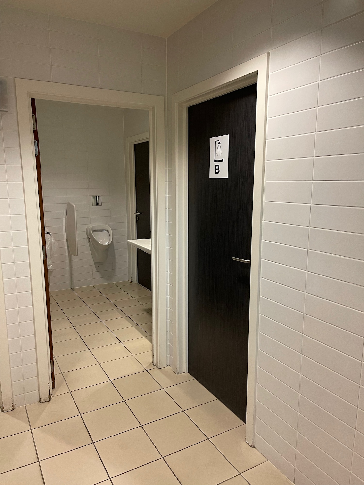 a bathroom with a urinal and a urinal