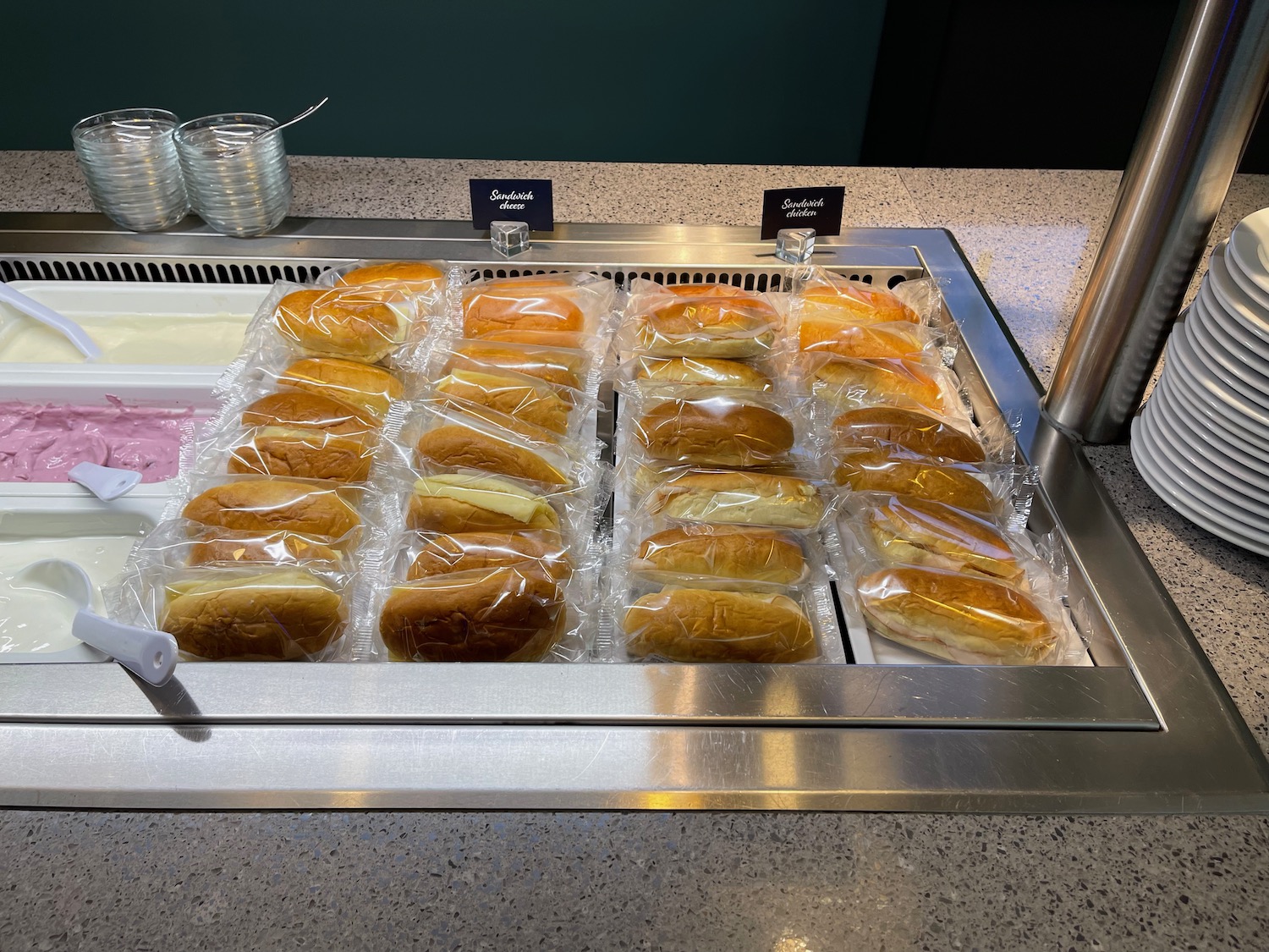 a tray of sandwiches in plastic wrap