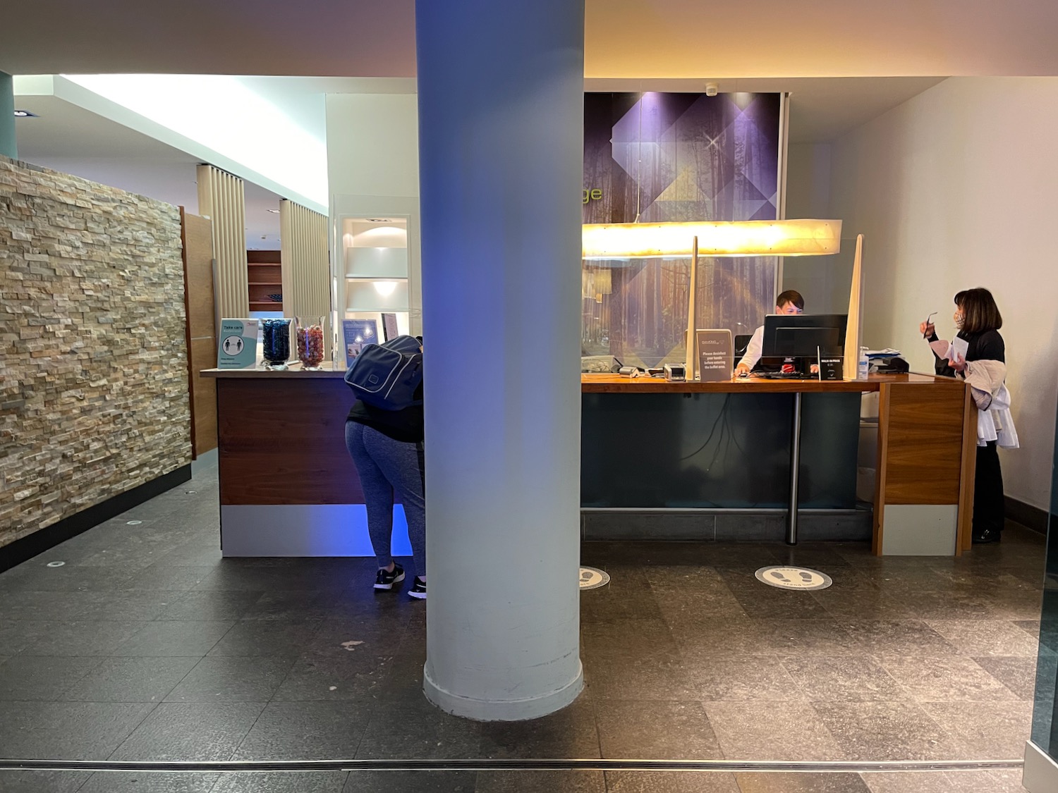 a person standing at a counter in a hotel