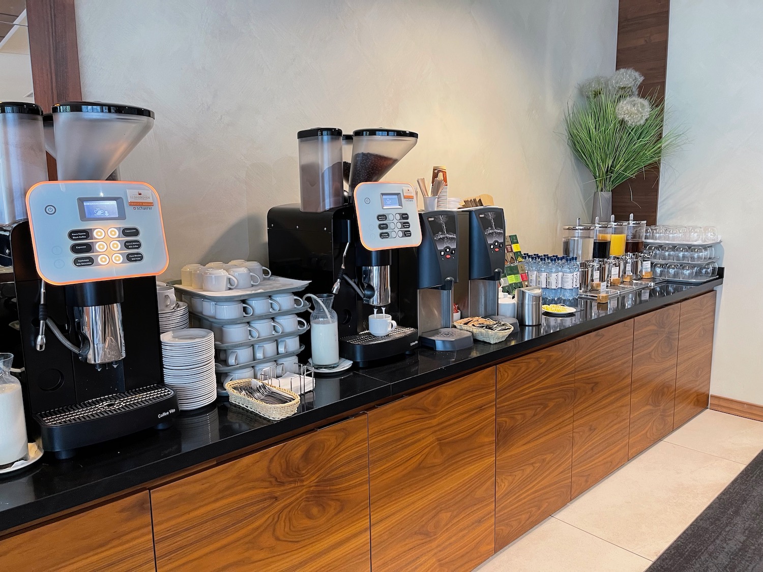 a counter with coffee machines and cups