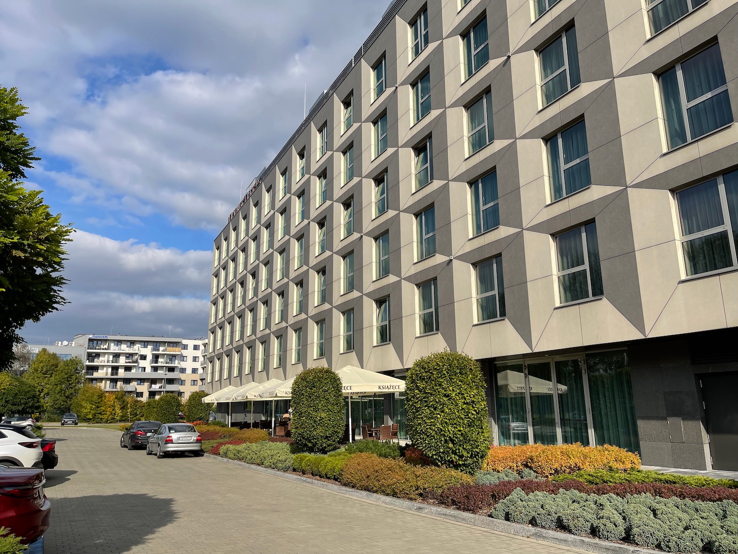 a building with many windows and a parking lot