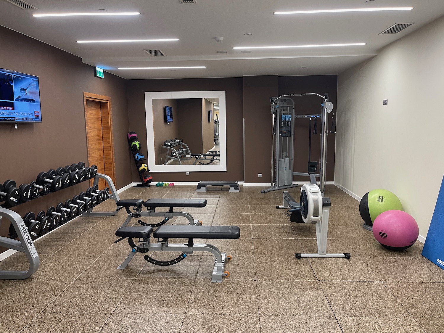 a room with exercise equipment and a mirror