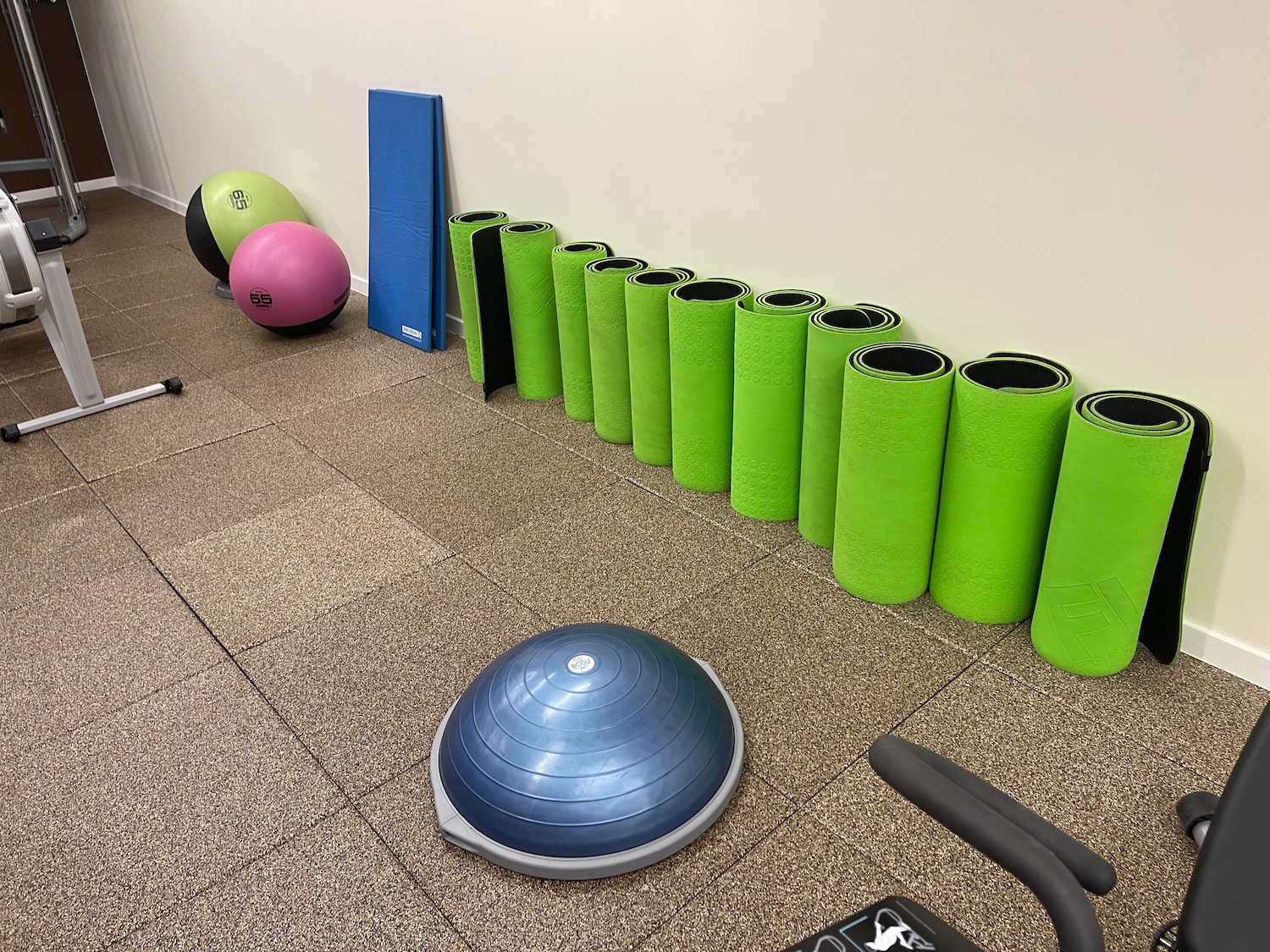 a group of yoga mats and exercise balls