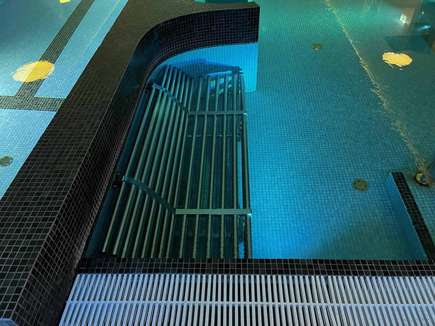 a swimming pool with a metal grate