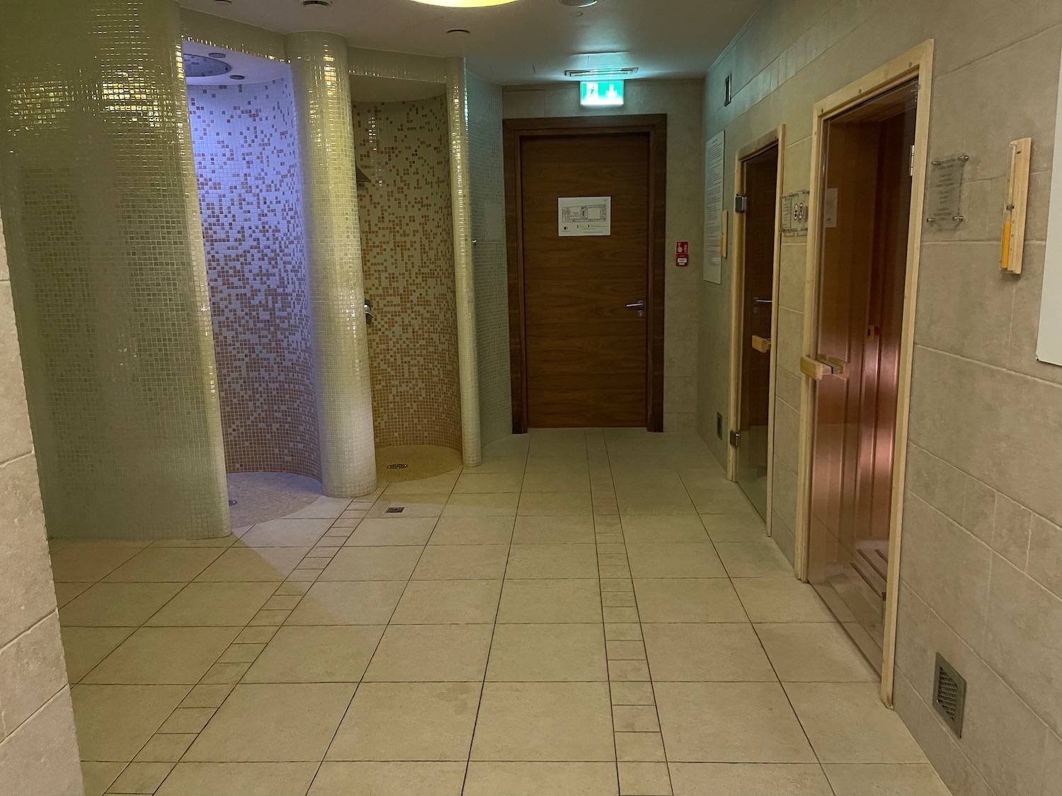 a hallway with doors and a tile floor